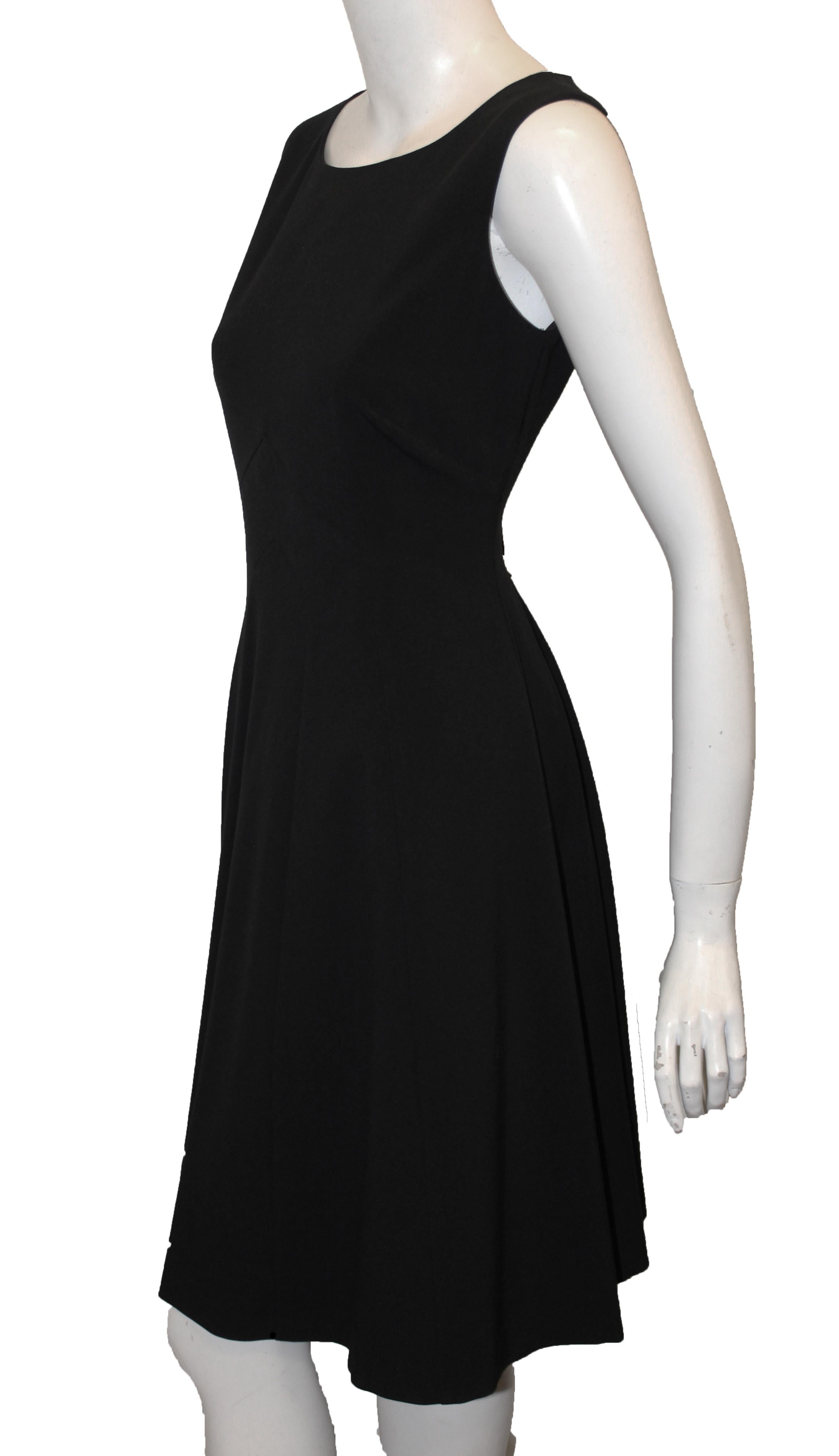 Only Burberry could make such a beautifully tailored sleeveless dress with perfectly tailored shape enhancing seams on the front and back.  Made in England, this simple, classic dress is composed of knitted stretch wool.  Back zipper and slightly