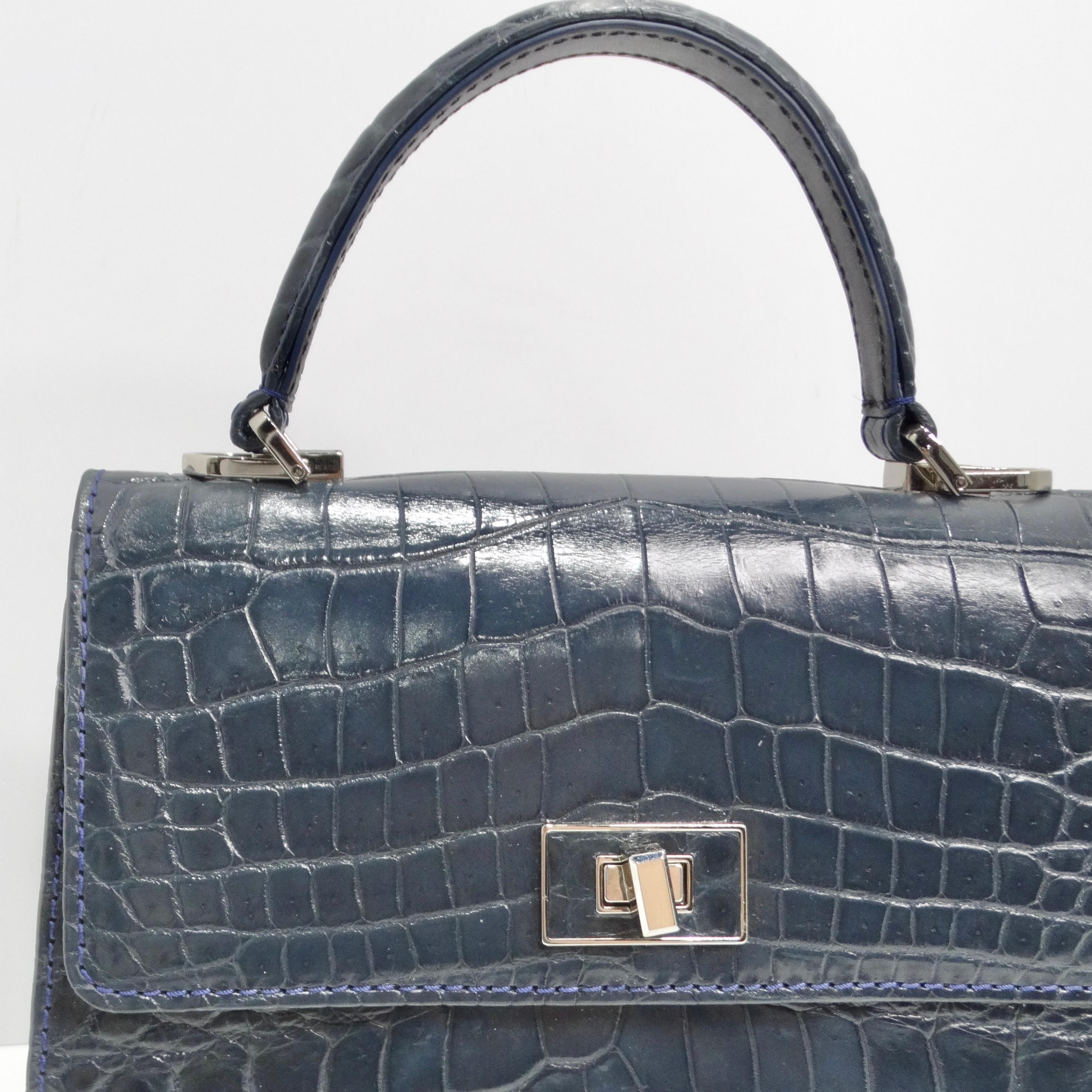 Le sac à poignée supérieure en cuir de crocodile bleu de BC Luxury est un accessoire étonnant qui allie l'élégance intemporelle à la sophistication moderne. Confectionné en luxueux cuir de crocodile bleu marine, ce sac structuré à poignée supérieure