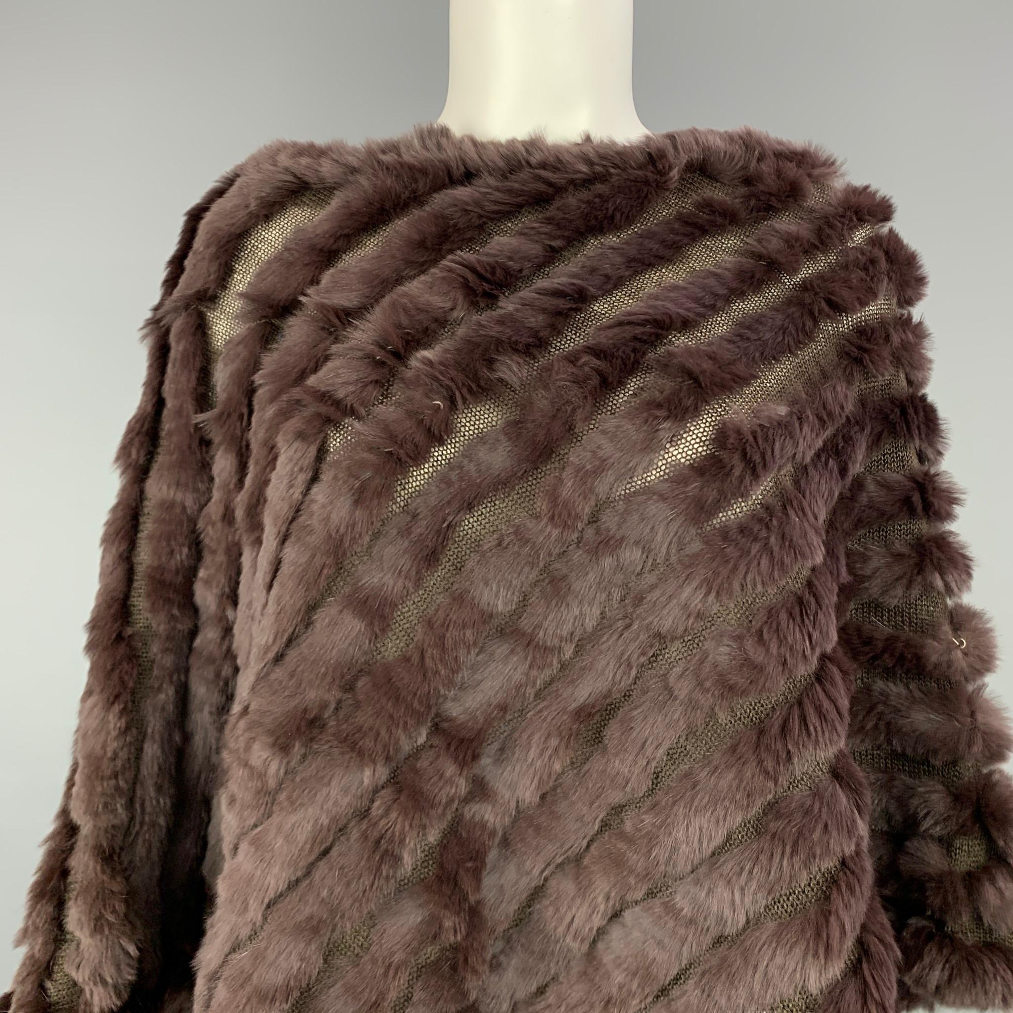 BCBG Max Azria poncho comes in a brown rabbit wool with a wool / acrylic base. 

Very Good Pre-Owned Condition.
Marked: One Size
Original Retail Price: $398.00

Measurements:

Shoulder: 17.5 in.
Length: 25 in. 