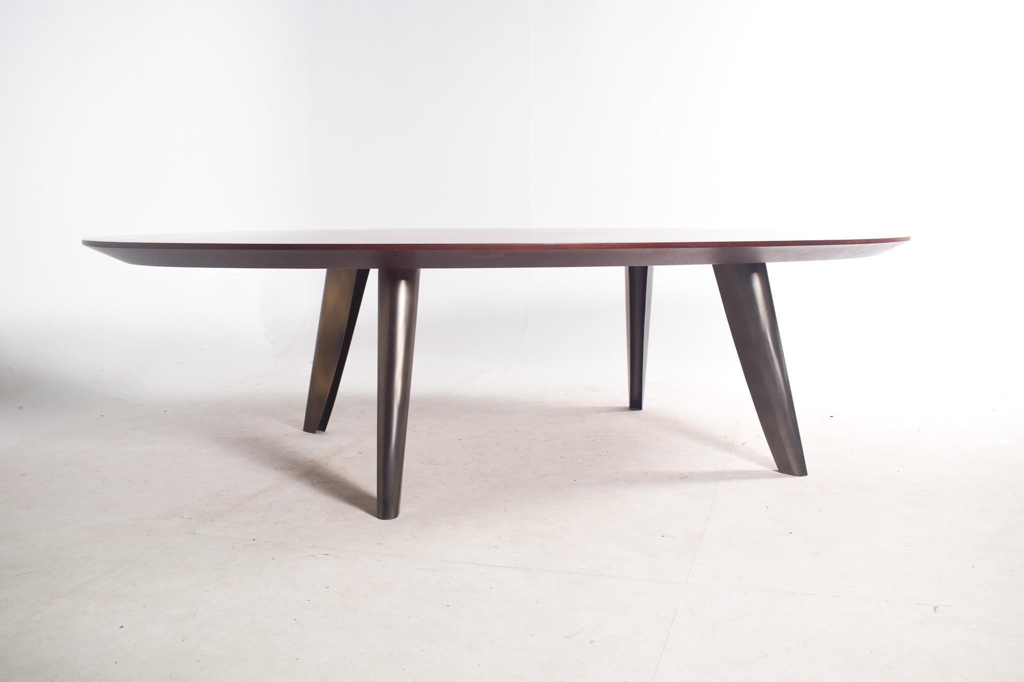 The BD 12 Rosewood Oval Table, designed by Laura Meroni for Bartoli Design, is a beautiful statement piece that brings elegance and sophistication to any home or office. This large oval table features a dark wood top, crafted from premium rosewood,
