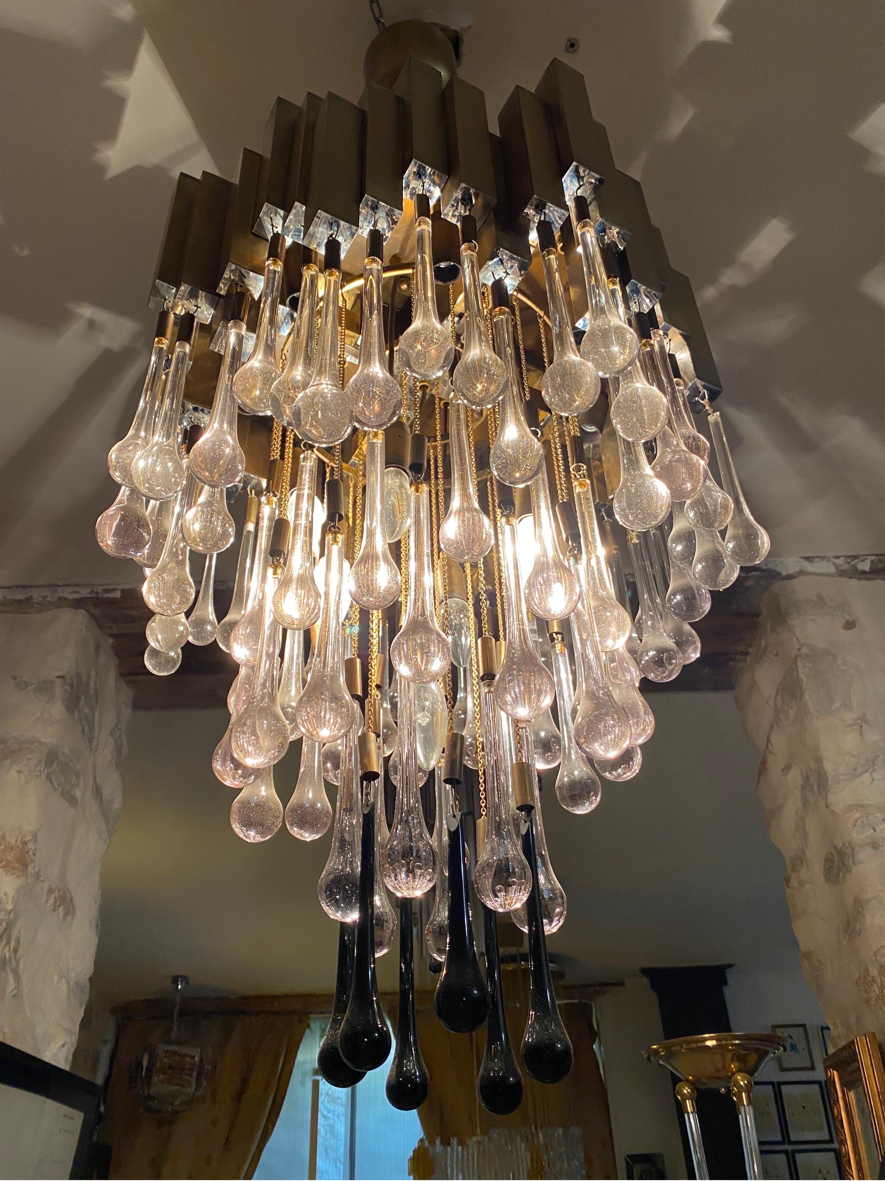 An exceptional, exclusive chandelier from the 70s. This piece was made in the 1970s in Barcelona, ?? by BD Lumica.

This piece is composed of golden brass, a chromed metal structure and 24 units of drop-bicolore mrano glasses.

discount shipping