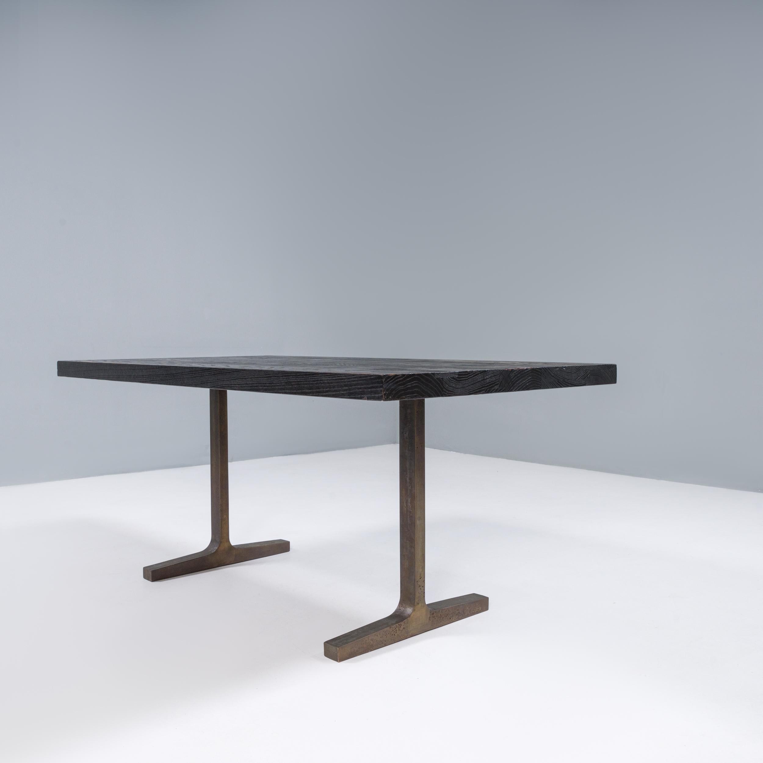 Designed by Tyler Hays in New York and manufactured in BDDW’s Philadelphia studio, this trestle table has been expertly crafted and made to last. 

Constructed from black walnut with a dark oil finish, the tabletop features butterfly joints in