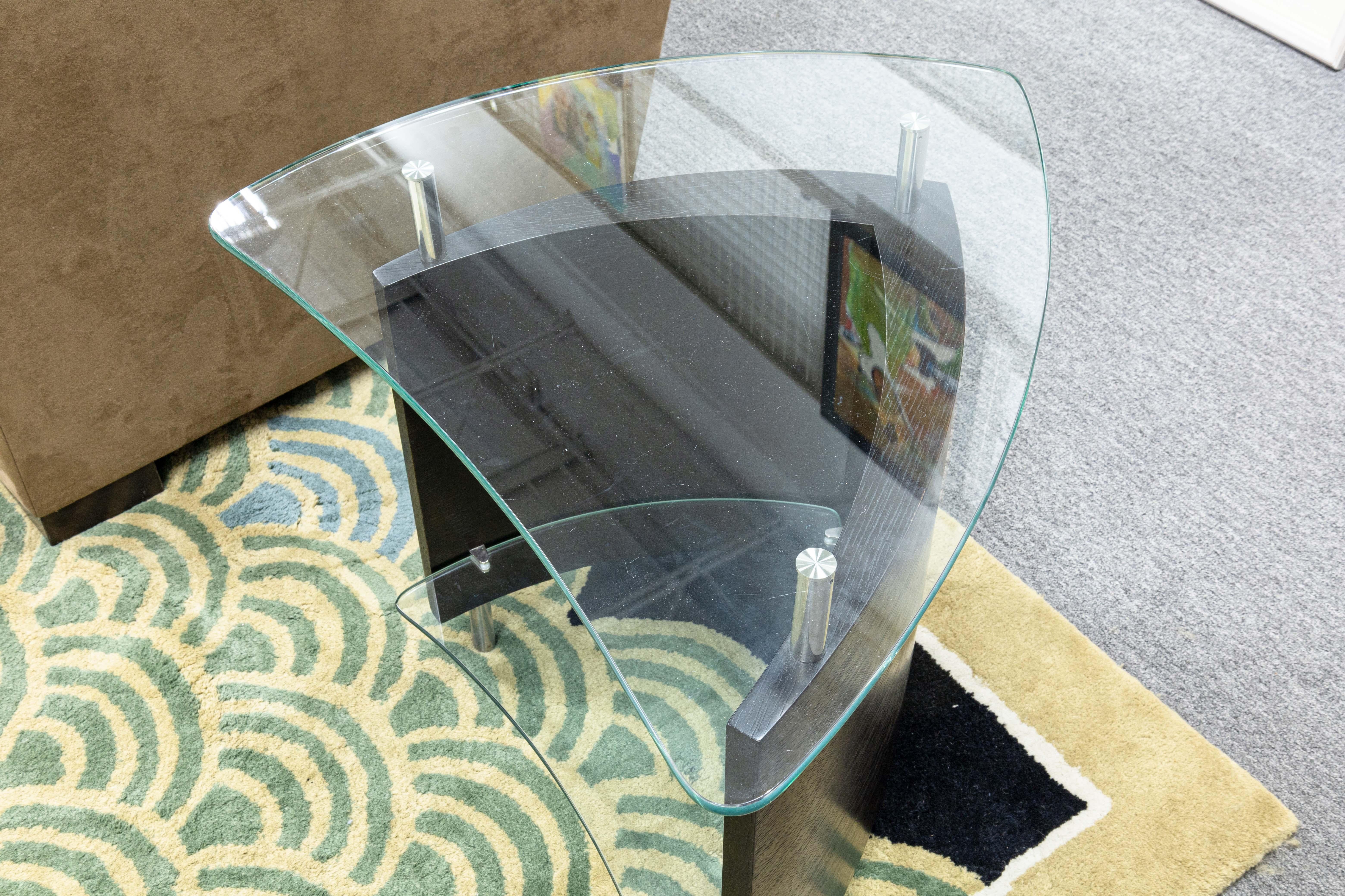 A BDI Furniture Fin 1110 side end table. A wonderful little table designed by Cristian Wicha for BDI. This little table features a two tiered table design, both with tempered glass. Each glass top is supported by nickel plated steel, and attaches to
