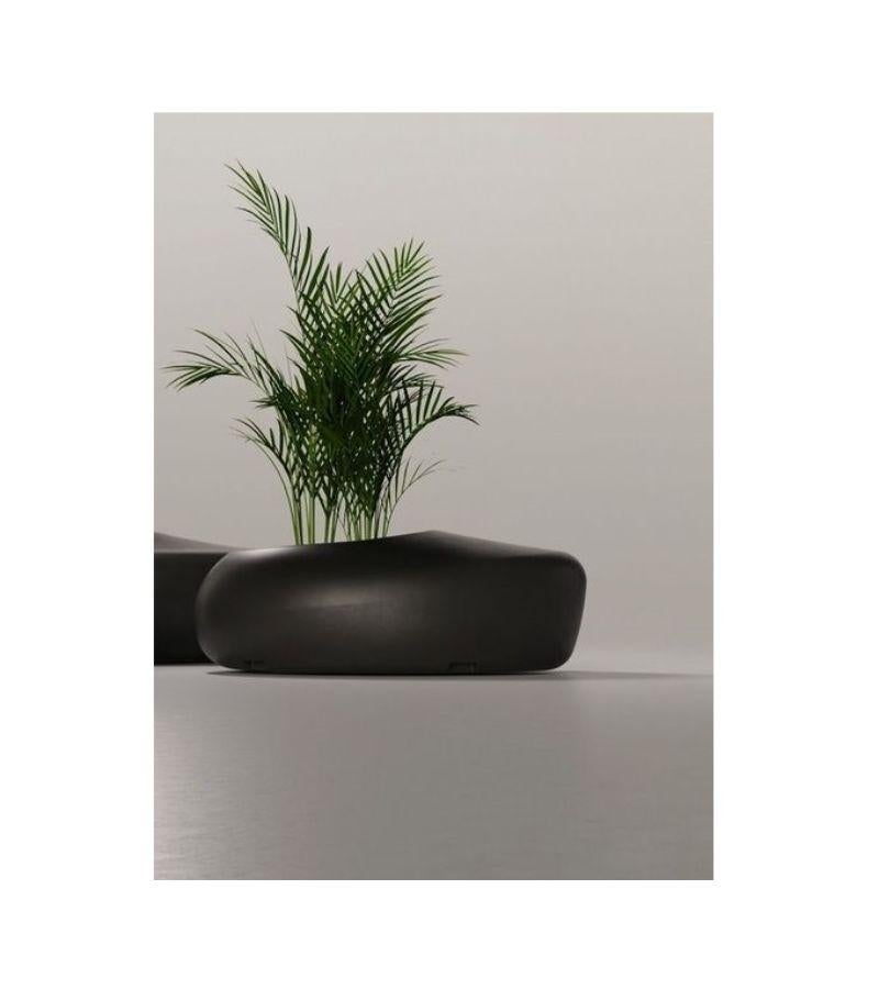 BDLove outdoor planter by Ross Lovegrove
Dimensions: D 100 x W 136 x H 48 cm 
Materials: Rotomolded polyethylene in anthracite gray. 100% recycled and recyclable. Optional dual A&C USB charger kit. Indoor use also. Could be stackable. 
Available