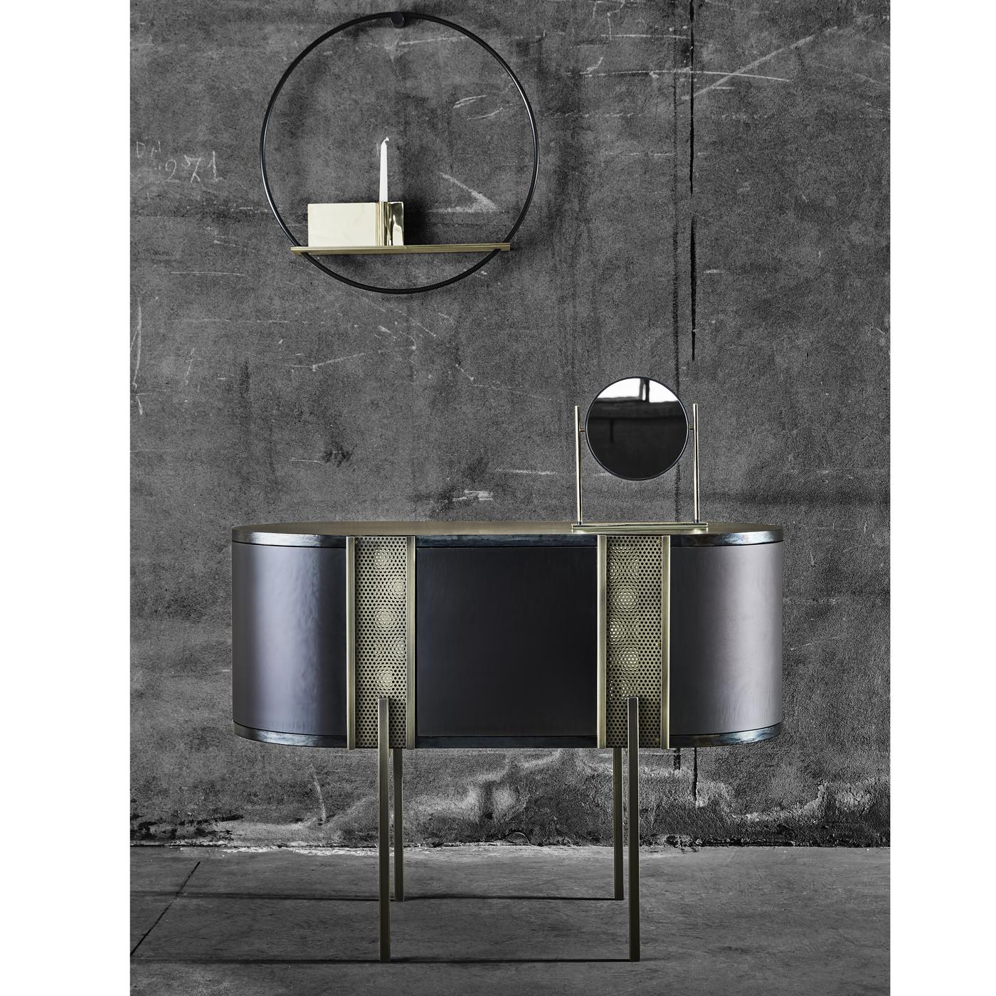 Designed by Lorenza Bozzoli, this sideboard can also double as a striking console in an entryway. Its contemporary design is made of four fine legs supporting a sinuous, elliptical shape accented with two nets that add grace and a touch of mystery