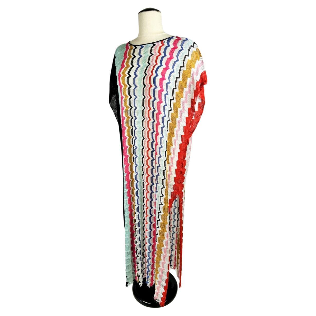 Circa 2010
Italy
Elegant summer beach or indoor dress by Missoni, Mare line dating from 2010. Wide, supple, sleeveless dress with round neckline and side slits. Stunning openwork knit in cotton and rayon forming multicoloured zigzags in a gradation