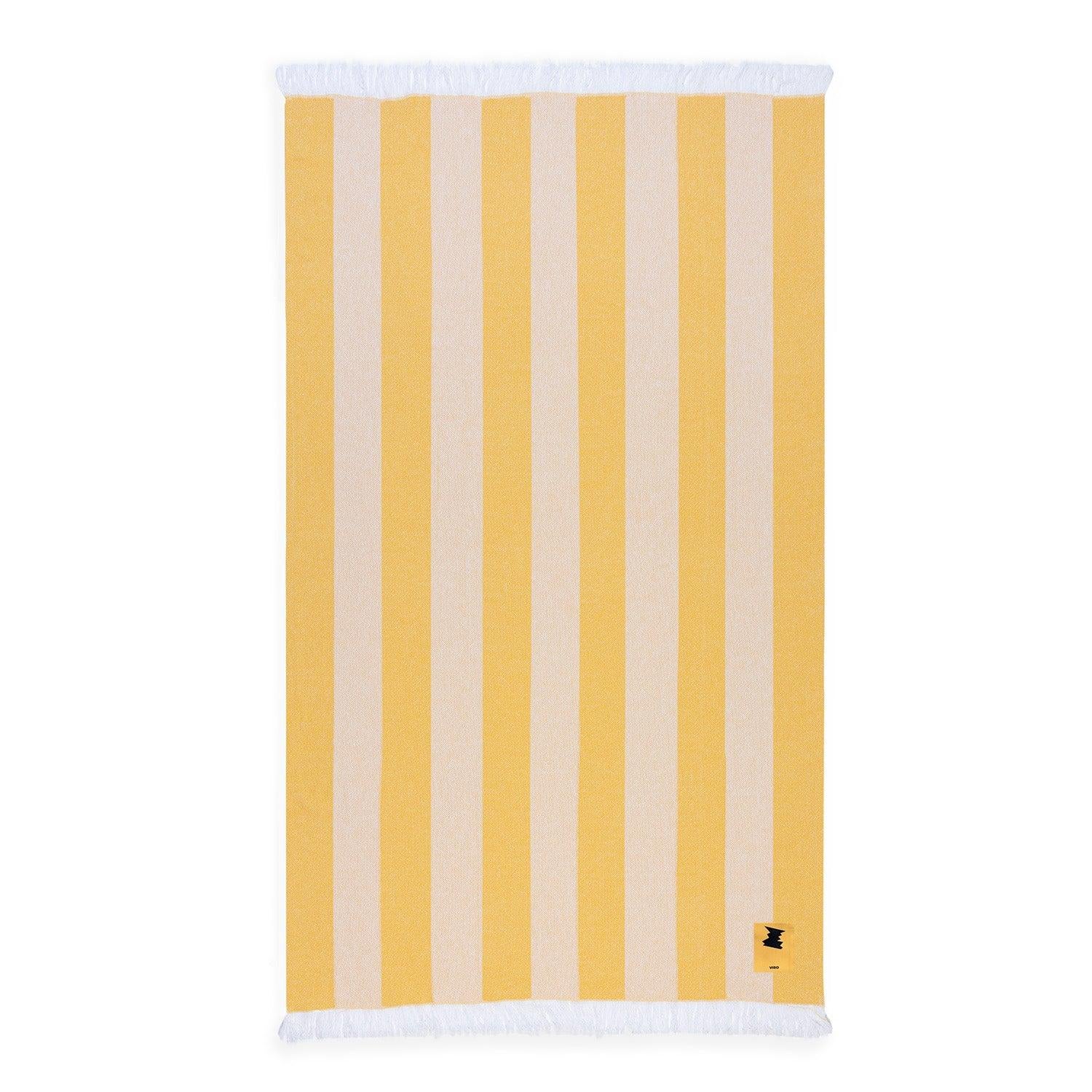 A cotton jacquard beach towel woven in a classic multi-stripe pattern of sunbeam yellow and white.
Available in two sizes—single and generous double—perfect for sunbathing solo or lounging with a partner.
It can also function as a lightweight