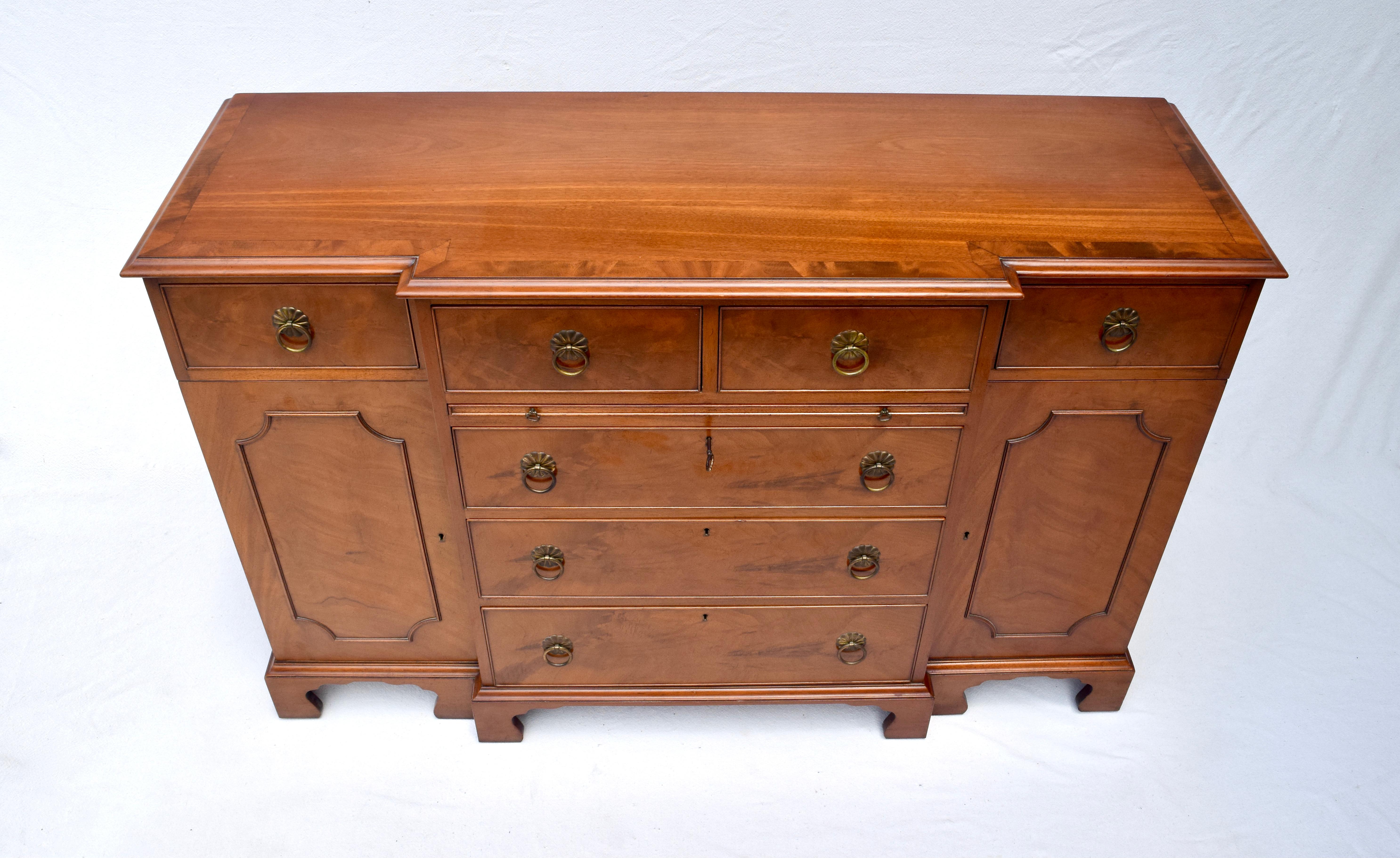 Beacon Hill Collection Chippendale style flame Mahogany sideboard credenza with banded inlay top, pull out embossed leather desk top surface & step up bracket feet. Considerable storage complete with adjustable shelving & two sets of removable solid