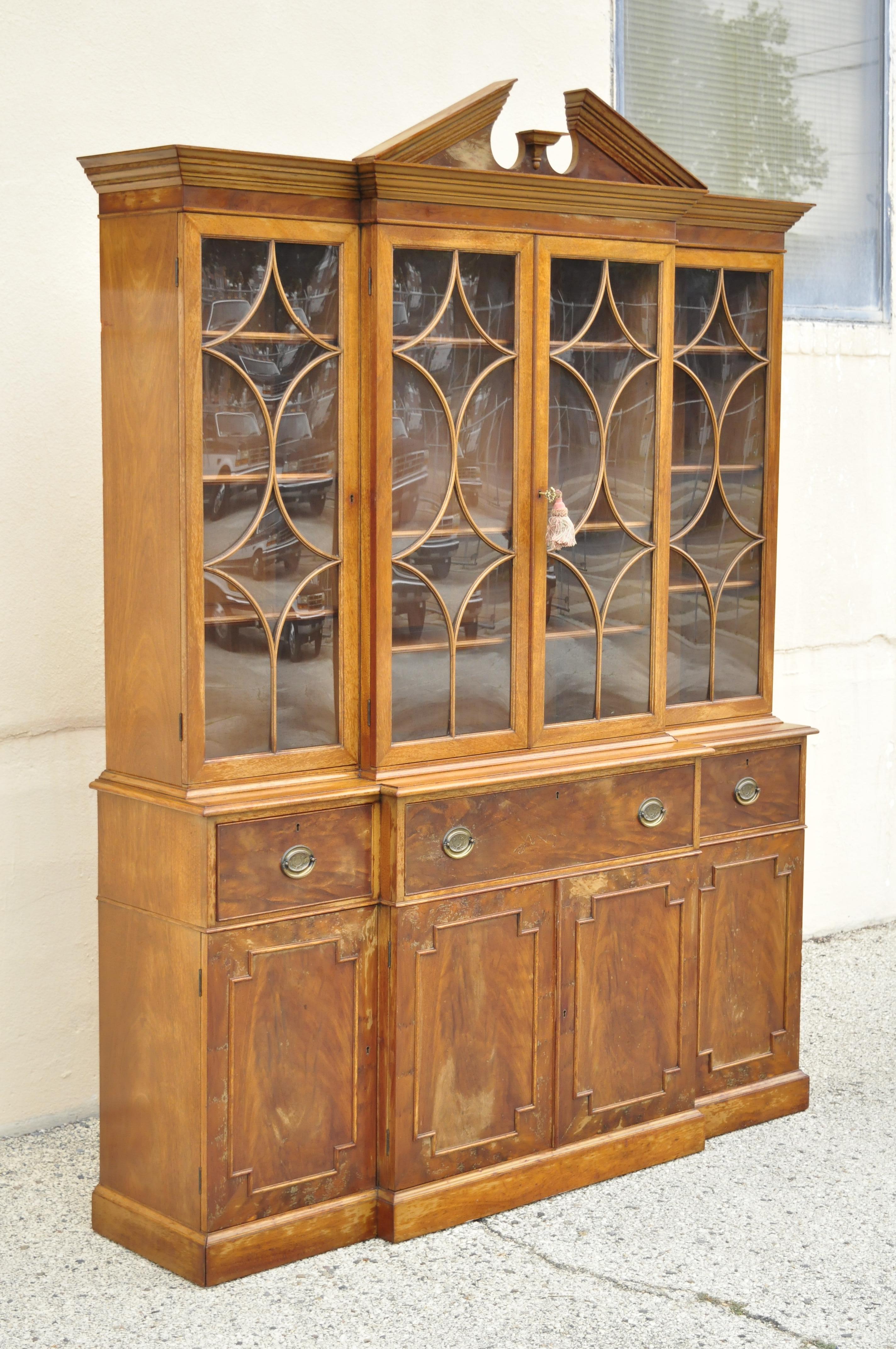 Beacon Hill Georgian style mahogany broken arch breakfront China cabinet secretary desk bookcase. Item features drop front desk surface with tooled leather top, beautiful wood grain, 2 part construction, original label, working lock and key, quality