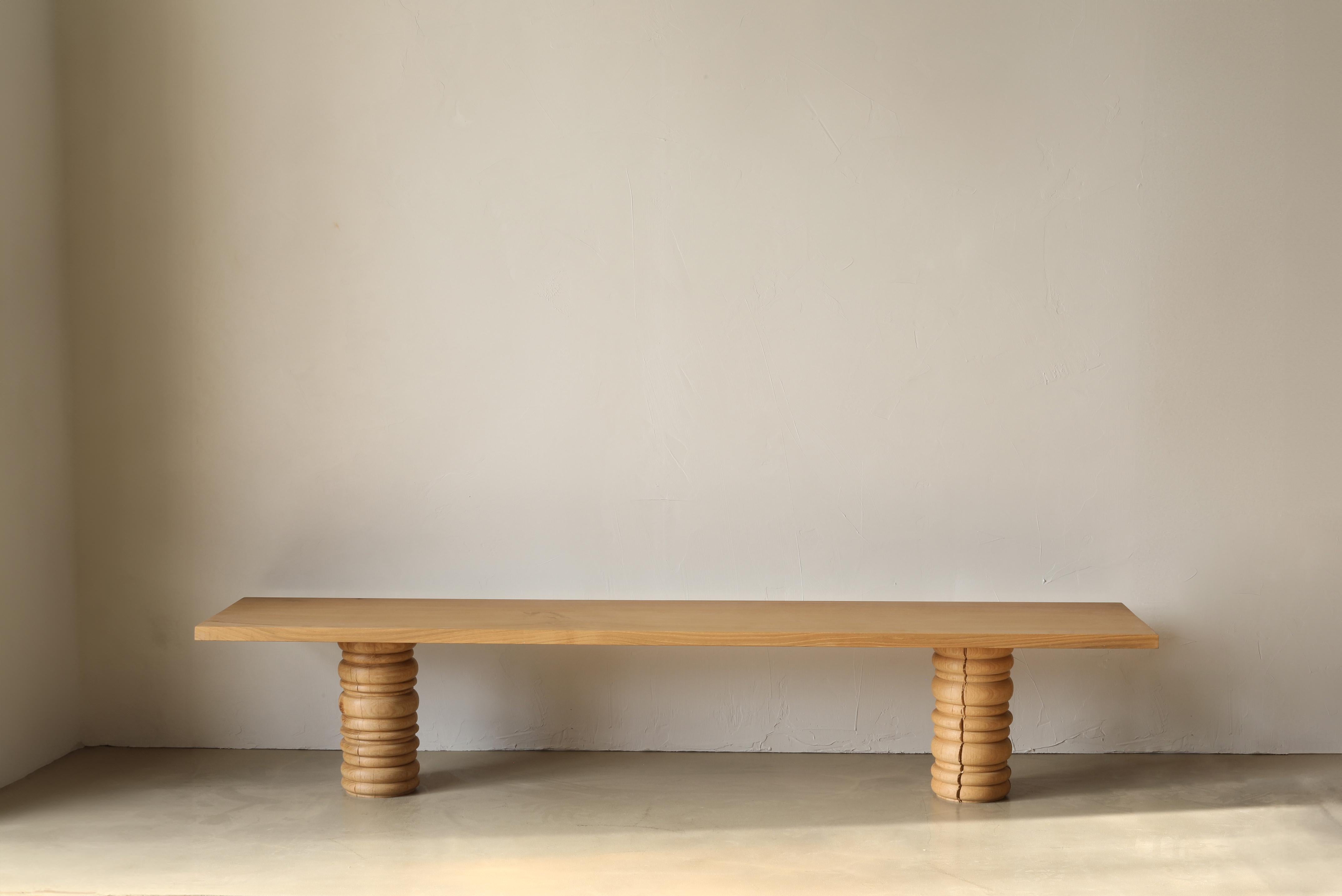 The Bead Bench is made up of turned pedestal bases for legs and a clean solid oak top. The Bead collection plays with the ornate nature of beaded turning techniques while establishing an indistinguishable pattern. Custom lengths are available.