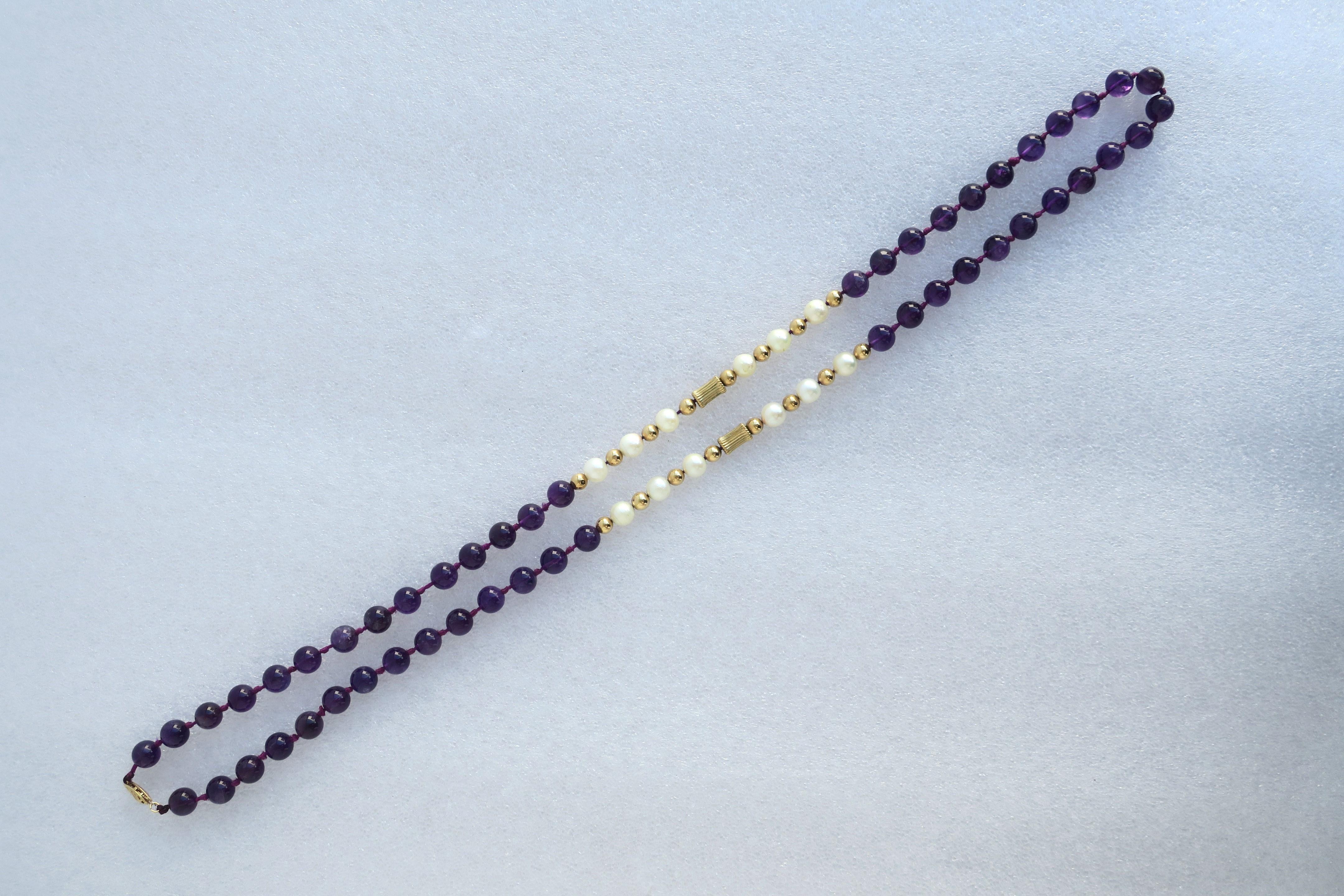 A vintage bead necklace comprised of purple amethyst-style beads, real cultured pearls, gold beads in two shapes, and 14-karat gold clasp (shown in last image.) Necklace measures 28