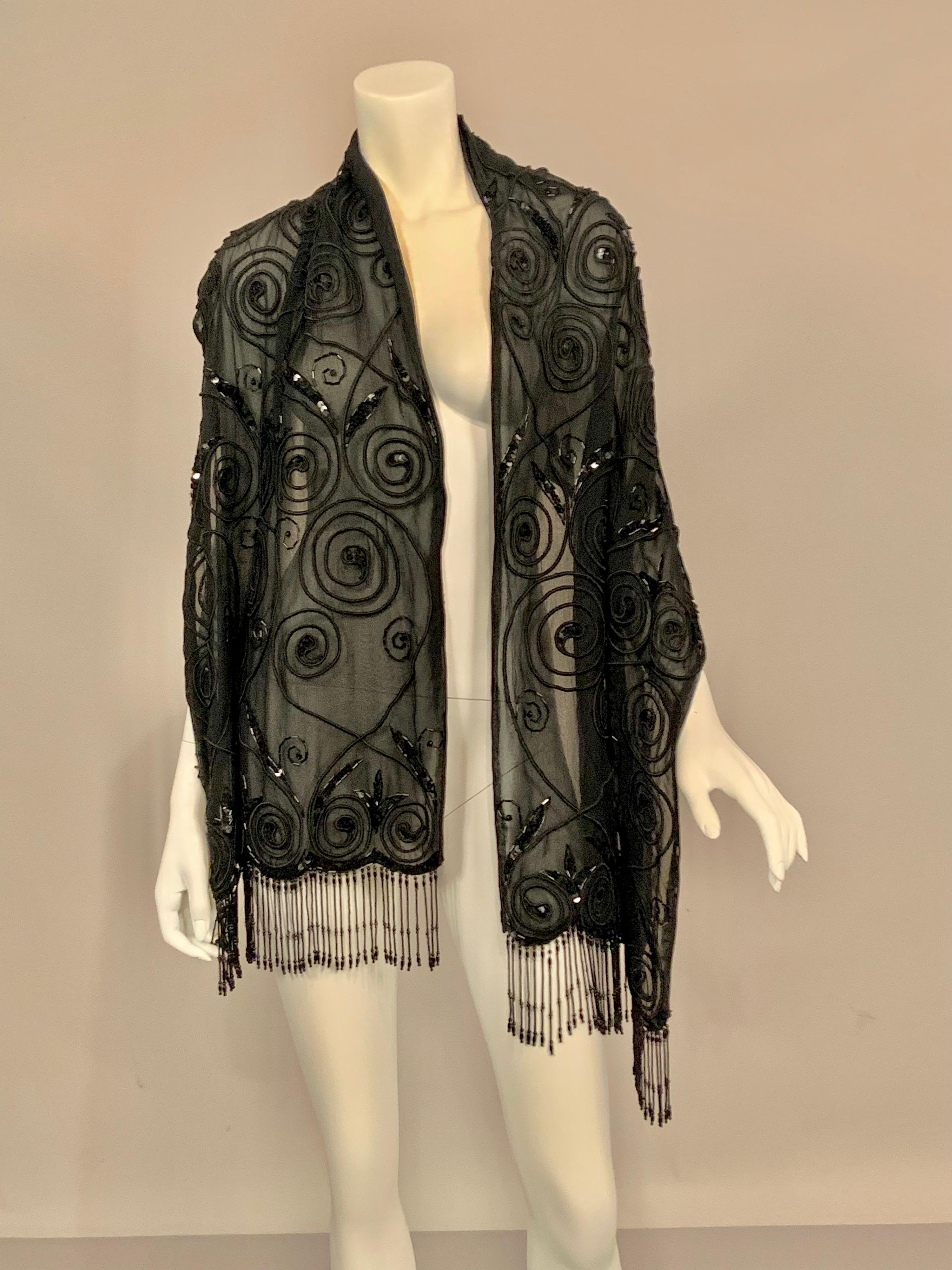 A scroll work of black silk soutache braid is enhanced by sequin and bugle bead motifs, as well as a fabulous beaded fringe.  All of this is stitched to black silk chiffon, which is lined with another layer of black silk chiffon.  The scarf or shawl