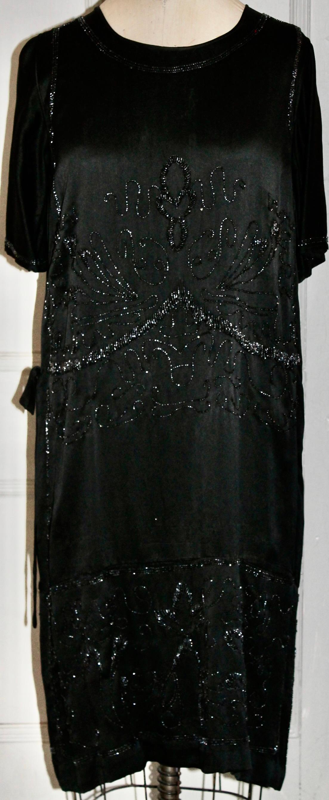 Silk 'Flapper' dress of the period with a drop waist design.  Interior attached silk slip.