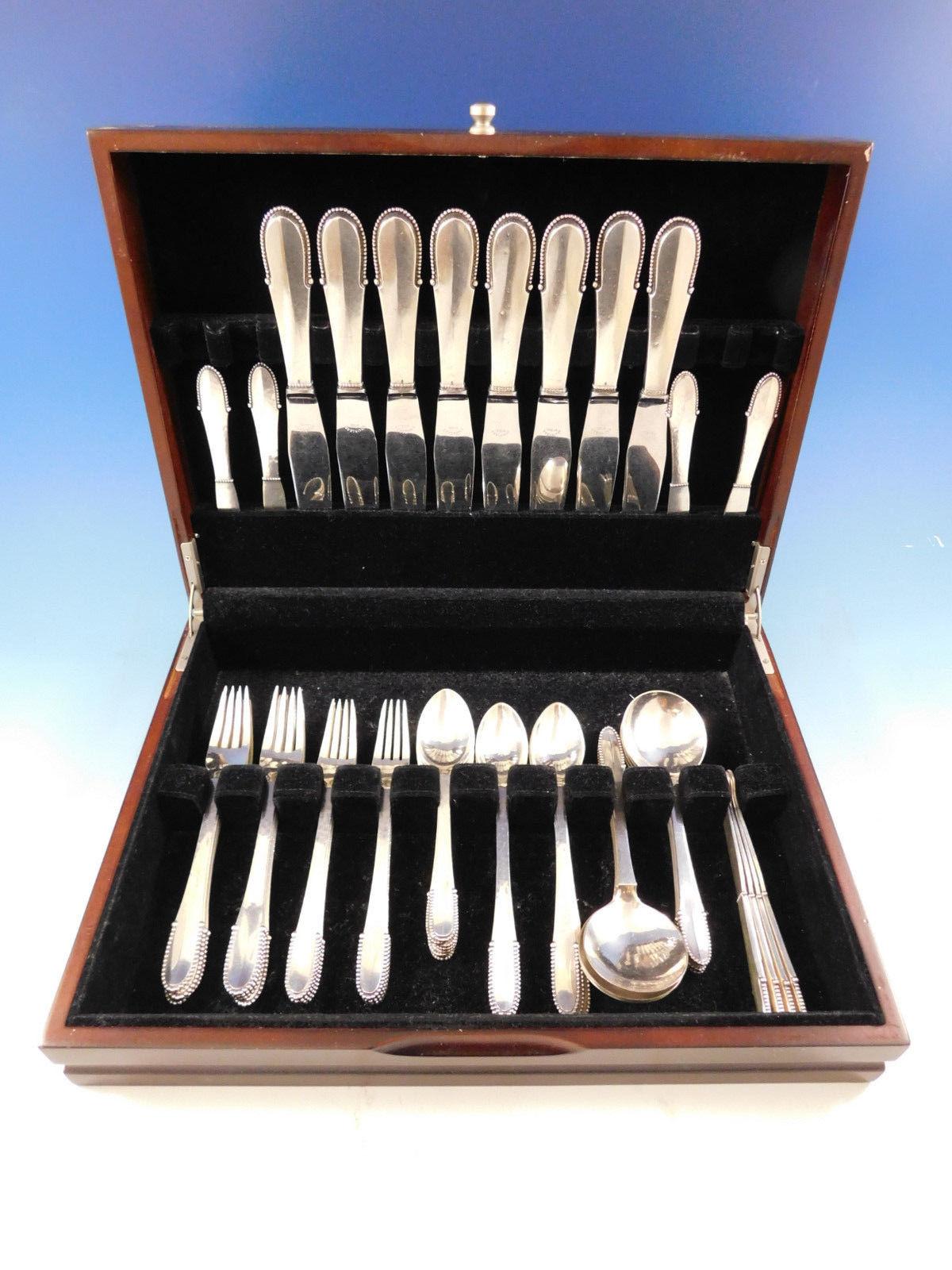Dinner size beaded by Georg Jensen sterling silver flatware set, 56 pieces. This set includes:

8 dinner size knives, short/wide handles, 8 7/8