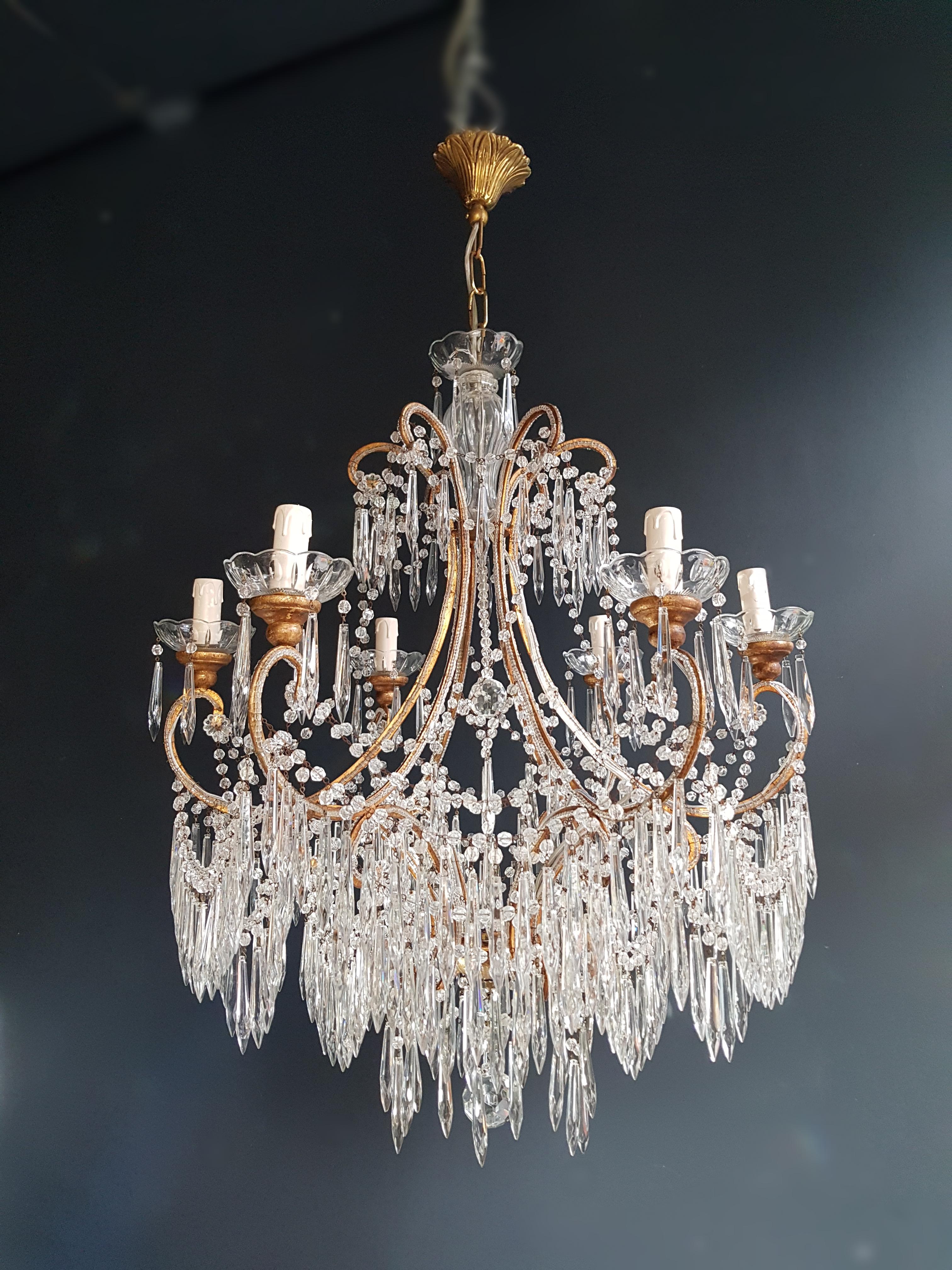 Beaded Florentine chandelier antique ceiling lamp lustre Art Nouveau.
The brass frame is surrounded all-over by beaded chains where pear drop cut crystals drops of different dimensions are hanging. Cut glass cups stand on the arms of the chandelier