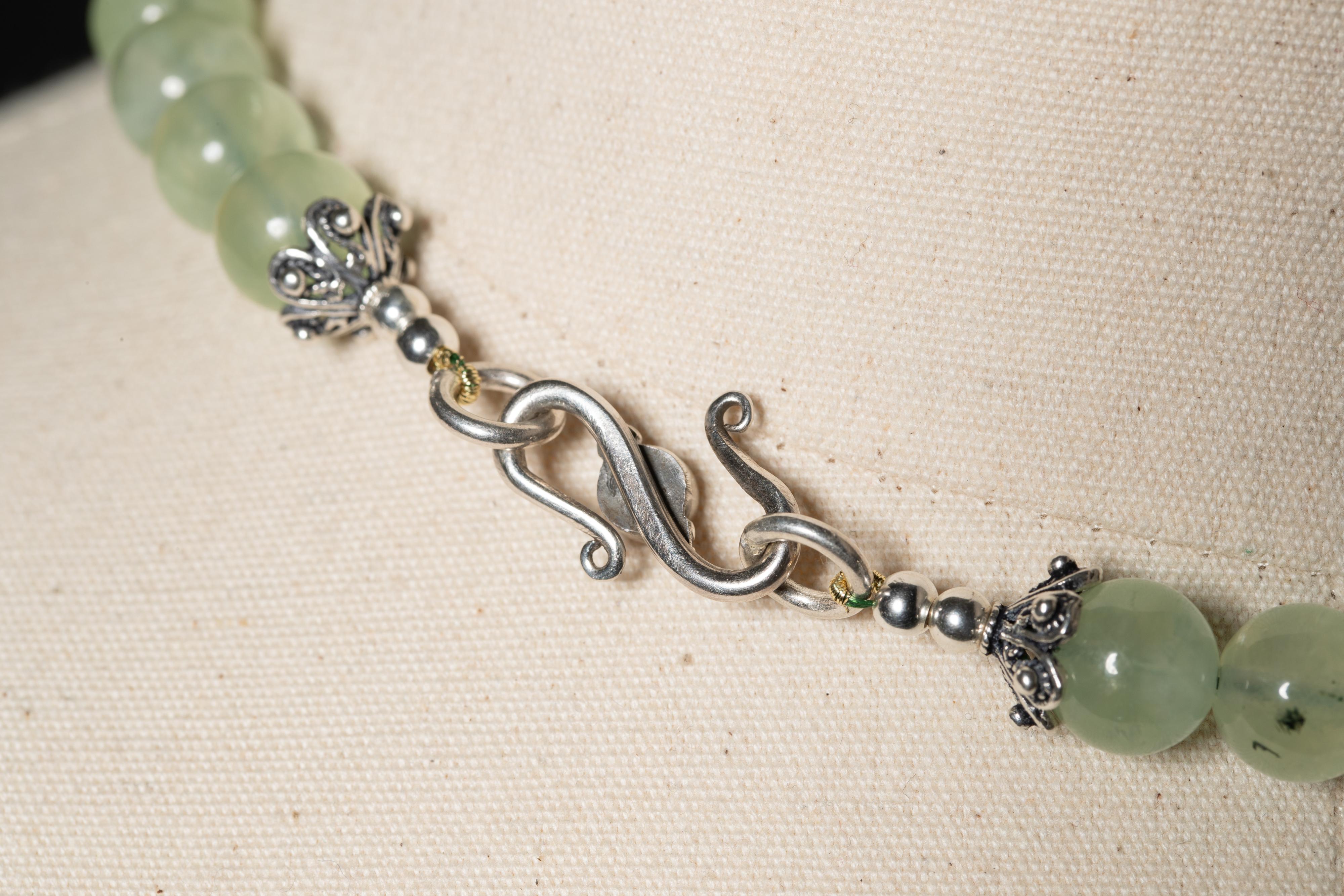 A nicely dimensional double-strand necklace of natural flourite in a spear shape with a range of colors from soft greet, blue and lavender.  Sterling silver end caps and round pranite beads across the back with a sterling silver S-hook with a