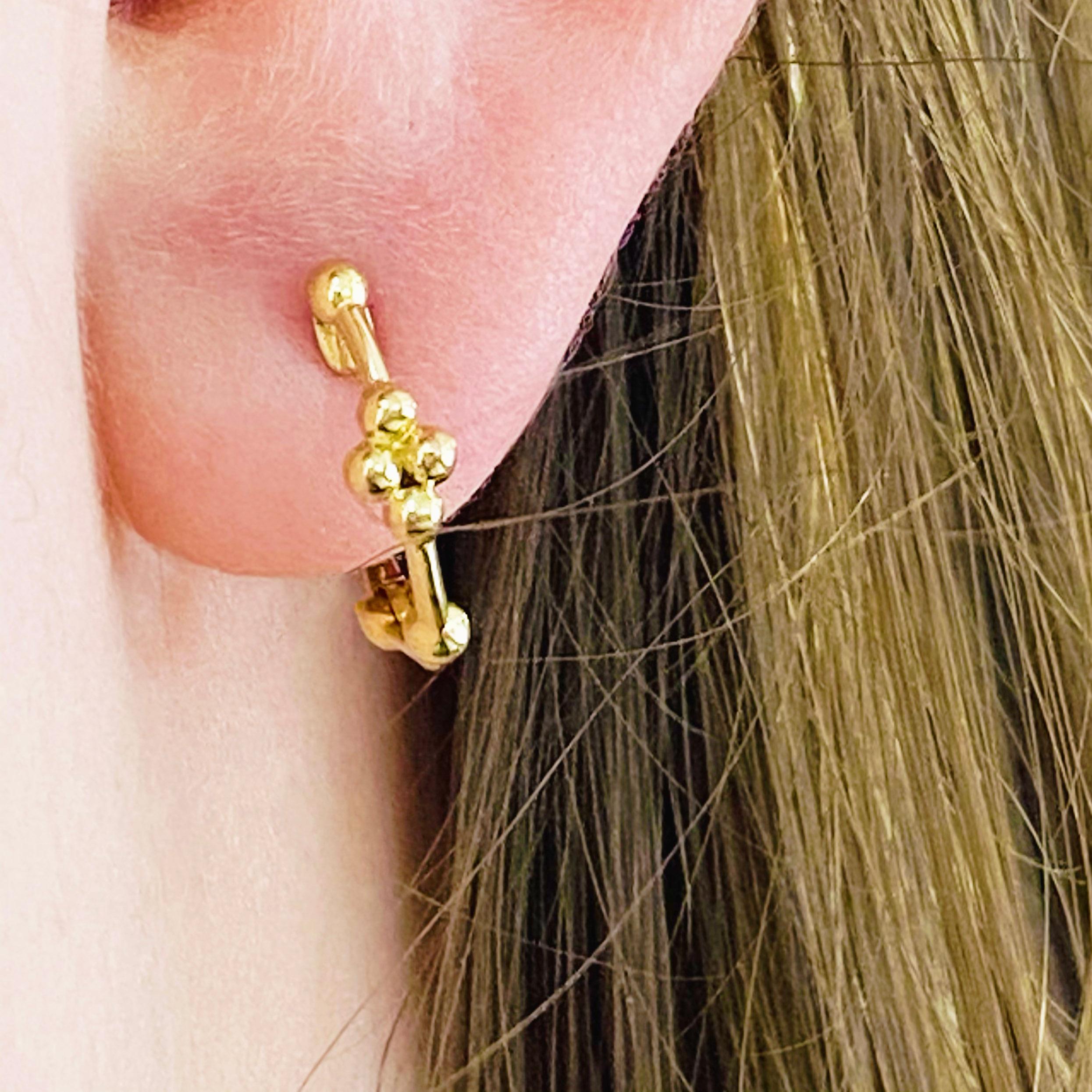These stunning 14k yellow gold beaded ball detailed huggie hoops provide a look that is both trendy and classic. These earrings are a great staple to add to your collection, and can be worn with both casual and formal wear.  These earrings would