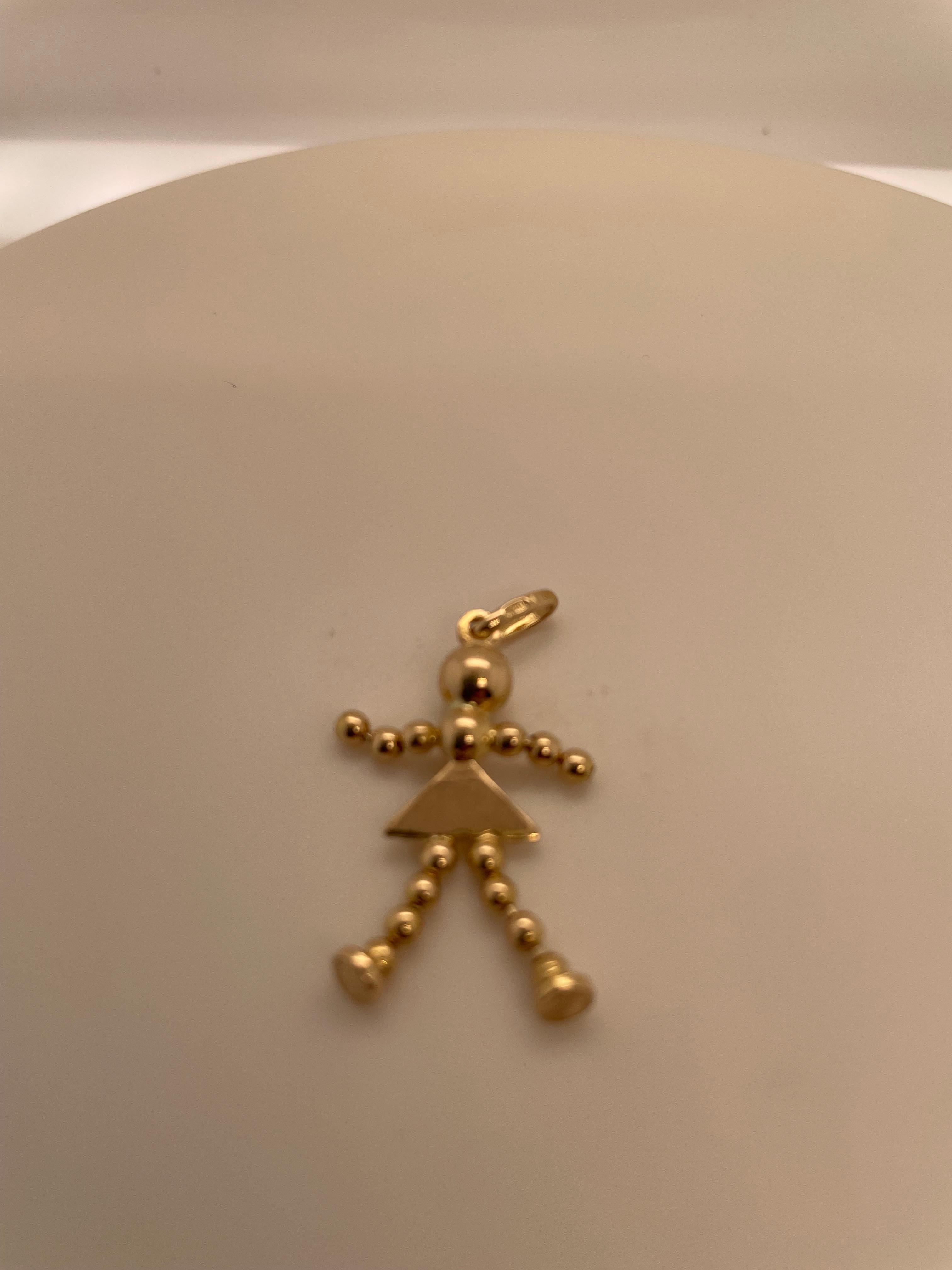 Adorable charm:  a little girl charm, with beaded arms and legs that move.  14K yellow gold.  1 1/4