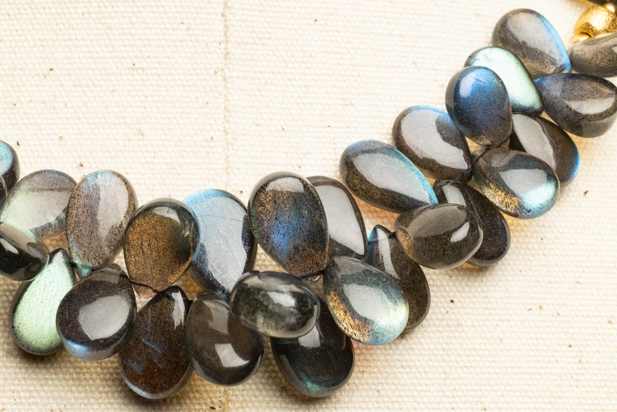 Rare Madagascar Labradorite briolette gemstones beads clustered to create dimension and texture.  With 18K gold plated beads with a lobster claw clasp and extra chain to to diversify the length between 18-20 inches.

The fine jewelry collection is