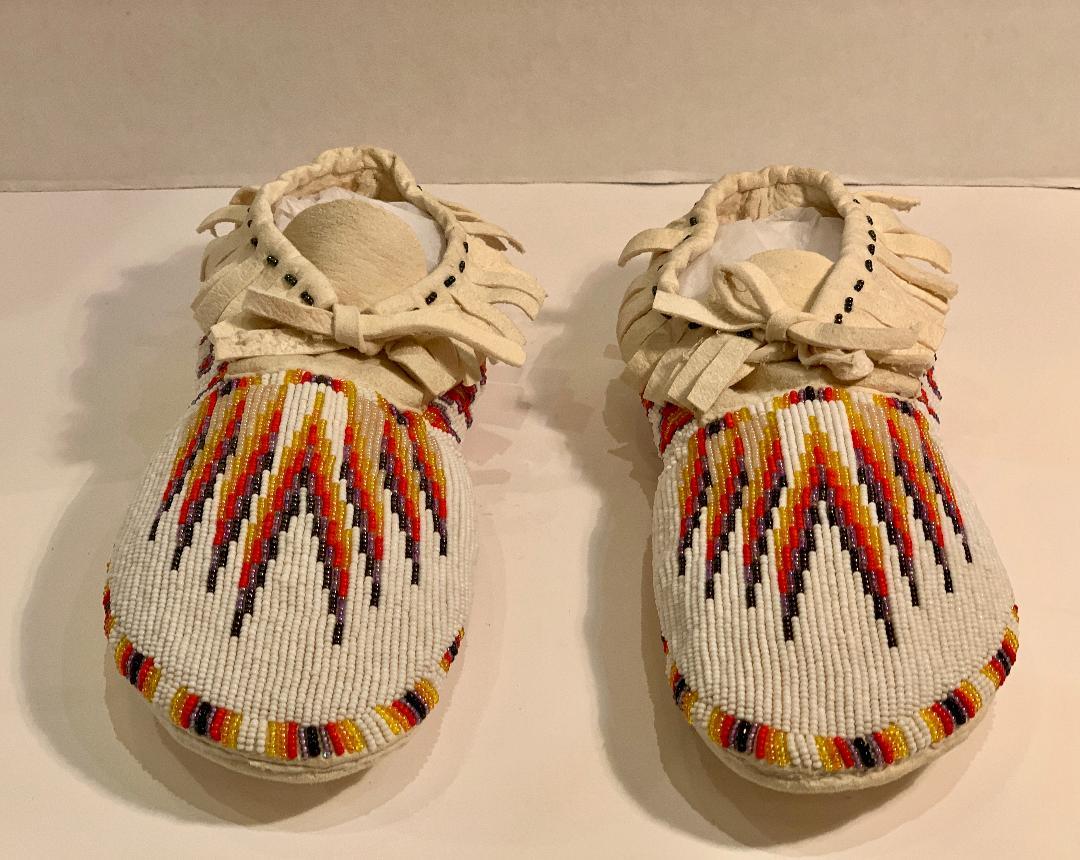 Very collectible, beautifully handmade Northern Paiute or Piute Native American Indian beaded moccasins feature striking contrasting colors of orange, yellow and espresso (near black). Hand applied glass seed beads are sewn to the exterior of the