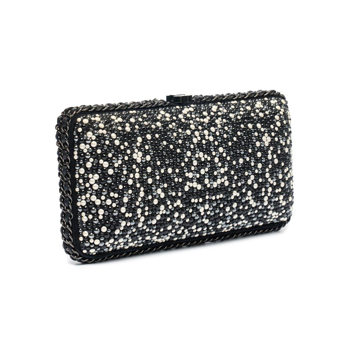 This elegant Beaded Pearl Clutch from Chanel is a must-have accessory for any formal occasion. Made with high-quality pearls and intricate beading, this clutch adds a touch of sophistication to any outfit. Its compact size makes it perfect for