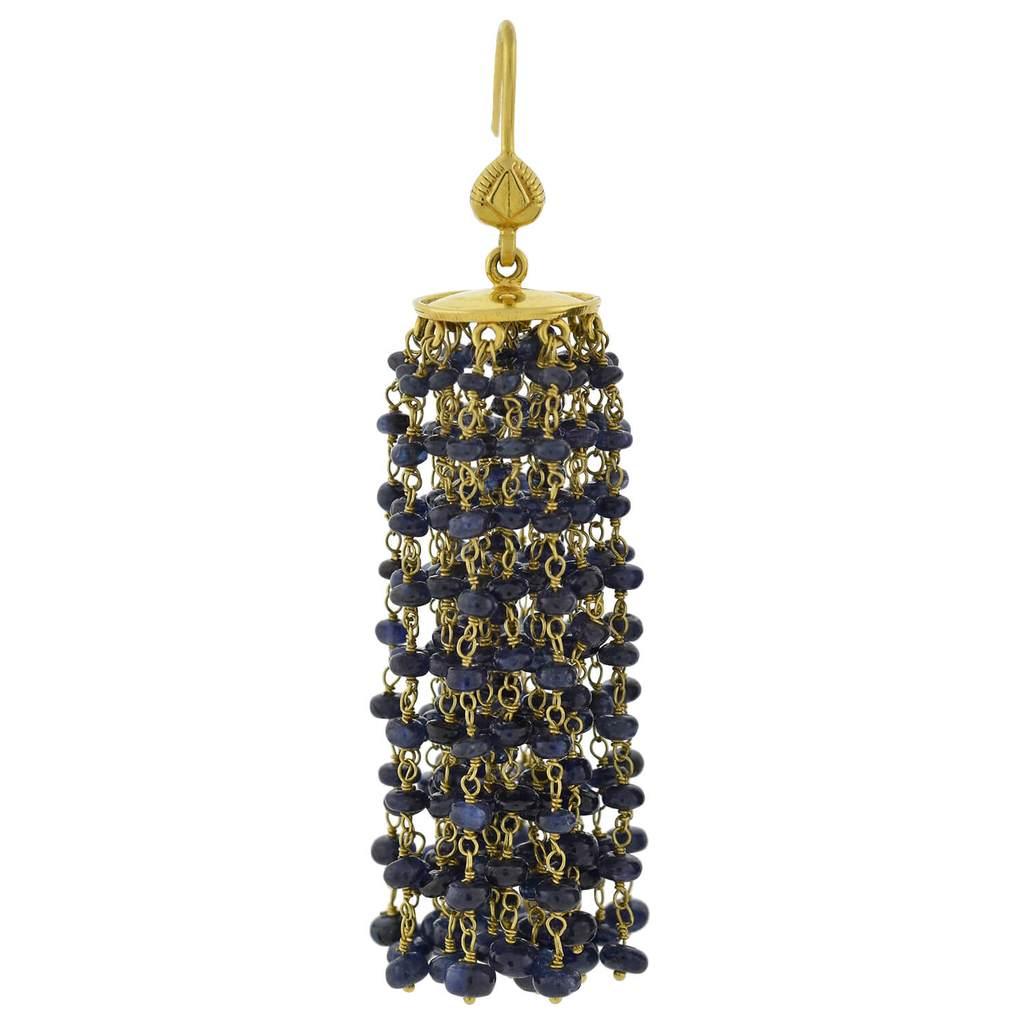 A fabulous pair of contemporary beaded sapphire tassel earrings! Crafted in 18kt yellow gold, each of these stylish earrings features a beveled gold disc that hangs from a simple earring wire. Attached on the underside of the discs are 27 strands of