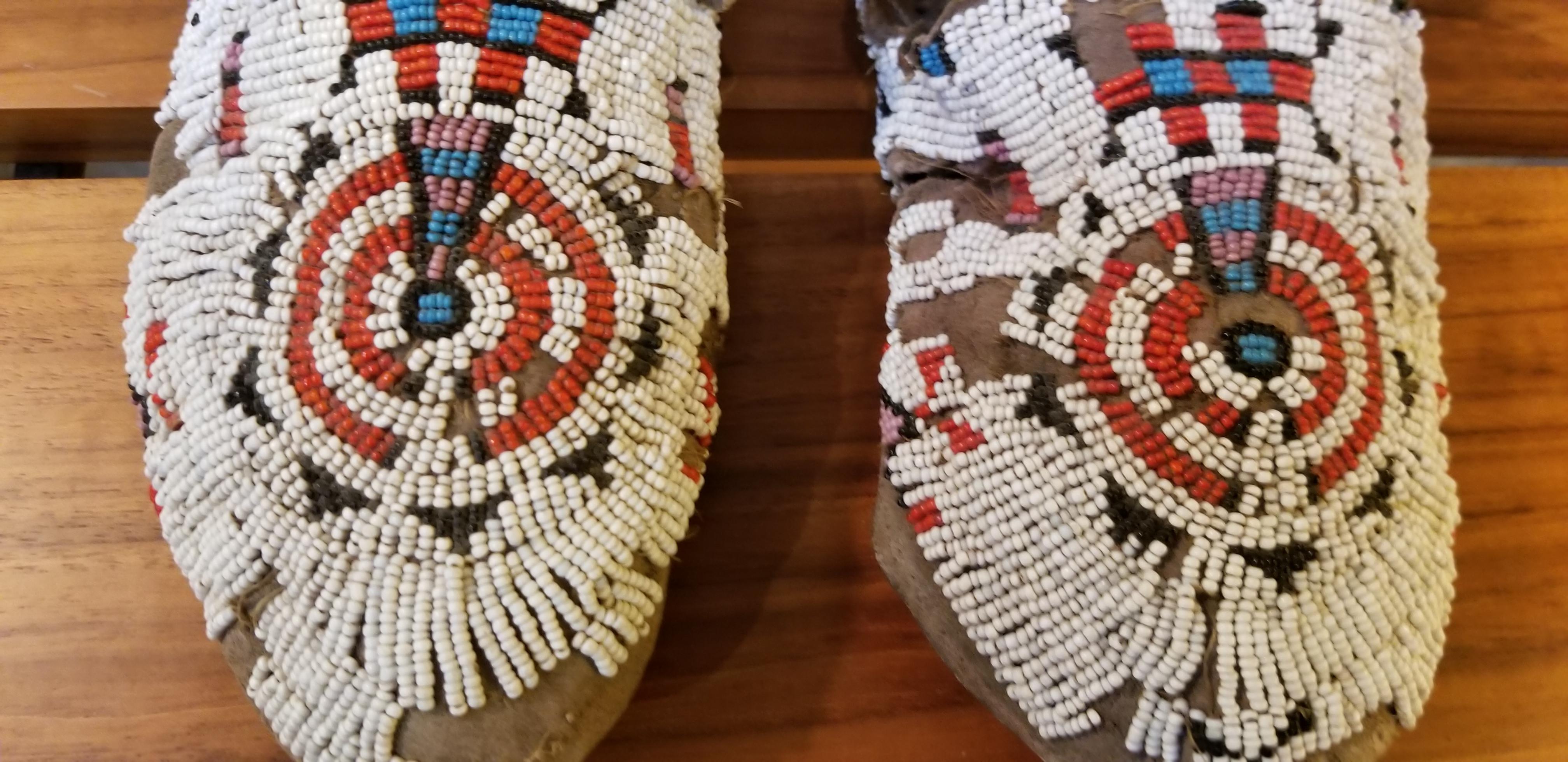 Authentic, antique beaded pair of Native American Sioux moccasins. Wear to leather and loss of beads from use. Late 19th-early 20th century.