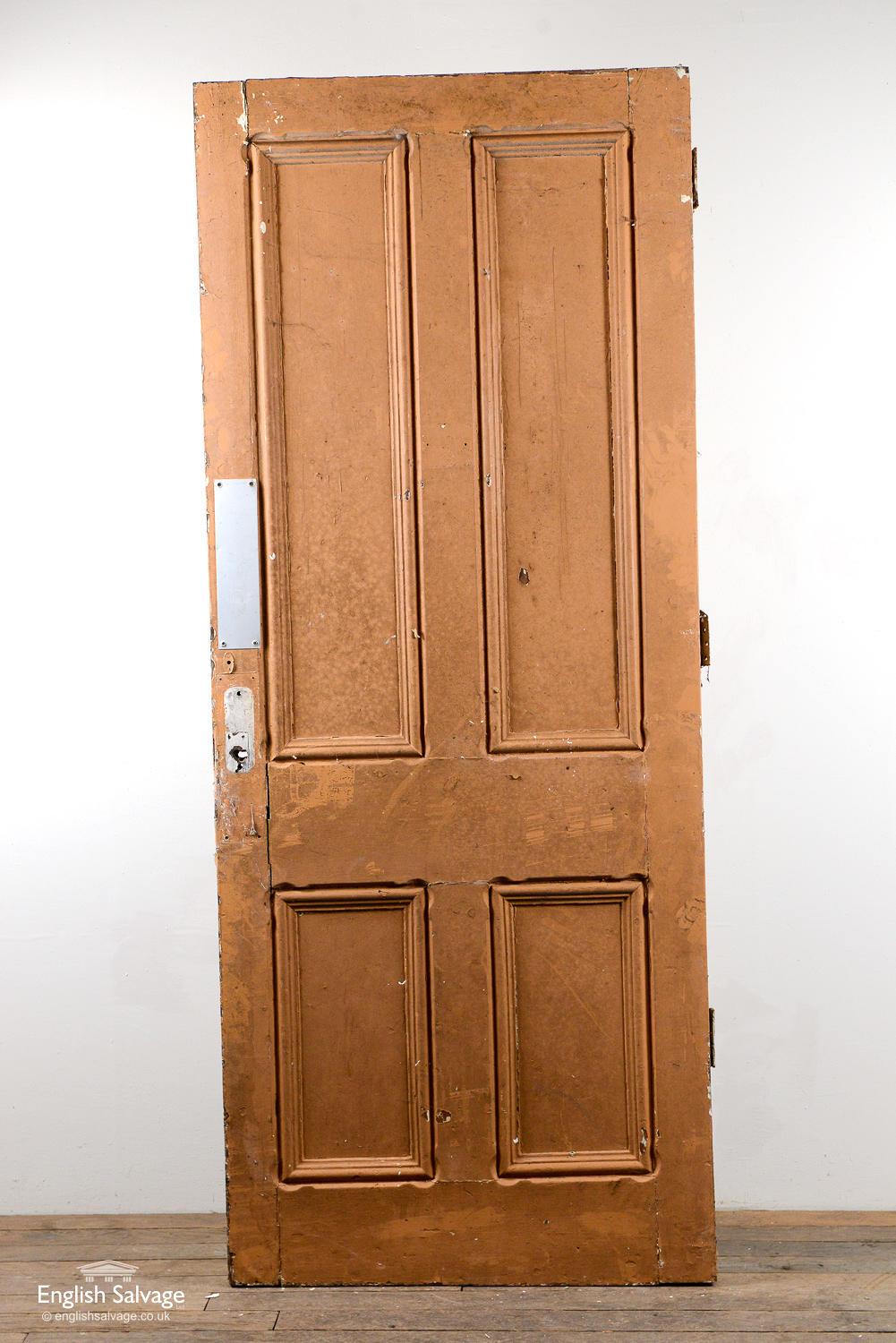 Reclaimed Victorian four panel pine door with three old hinges and a painted cream / yellow finish. Handle, lock and nail holes plus a few bumps to edges.