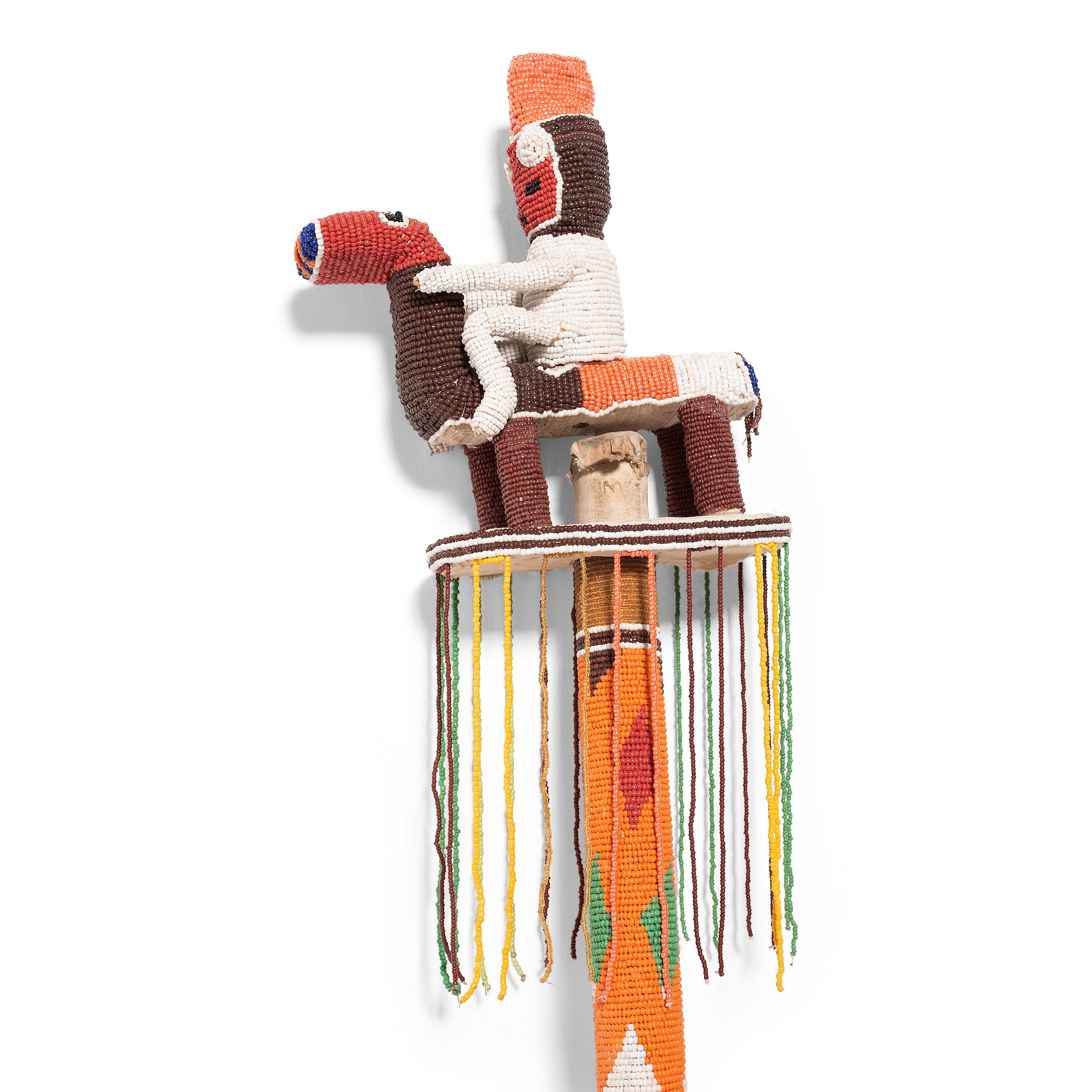 The Yoruba people reserve the use of glass beads for royalty, priests and priestesses, as well as embellishing ritual and ceremonial objects. Though only kings are allowed to use beaded regalia, this beaded staff serves as a surrogate for the ruler
