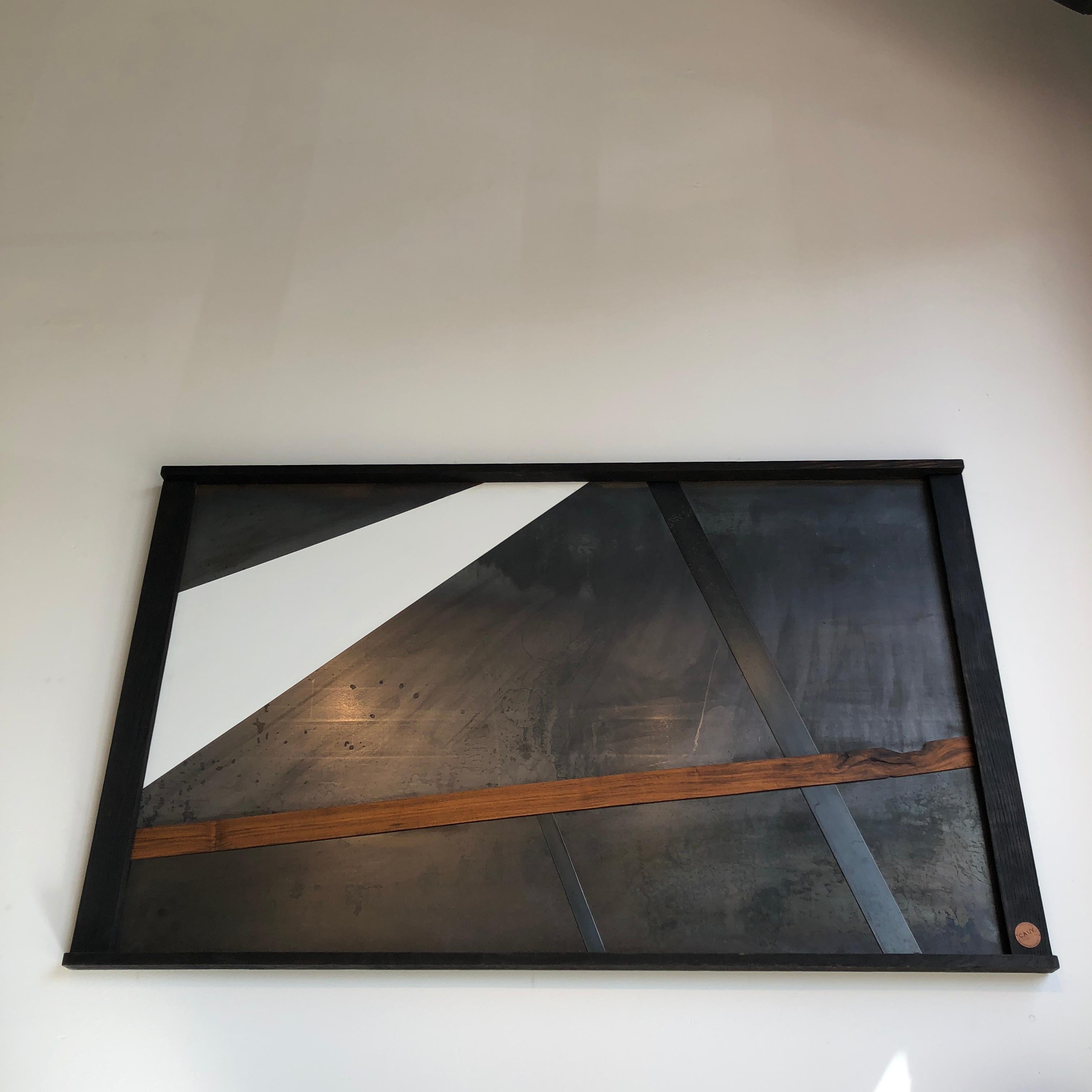 A three by five foot piece of wall art comprised of sheet steel, burnt oak, walnut or steel strips, and paint. Joseph offers his version of a canvas with this stunning piece of hand worked, blackened, sheet metal. Held inside the frame of