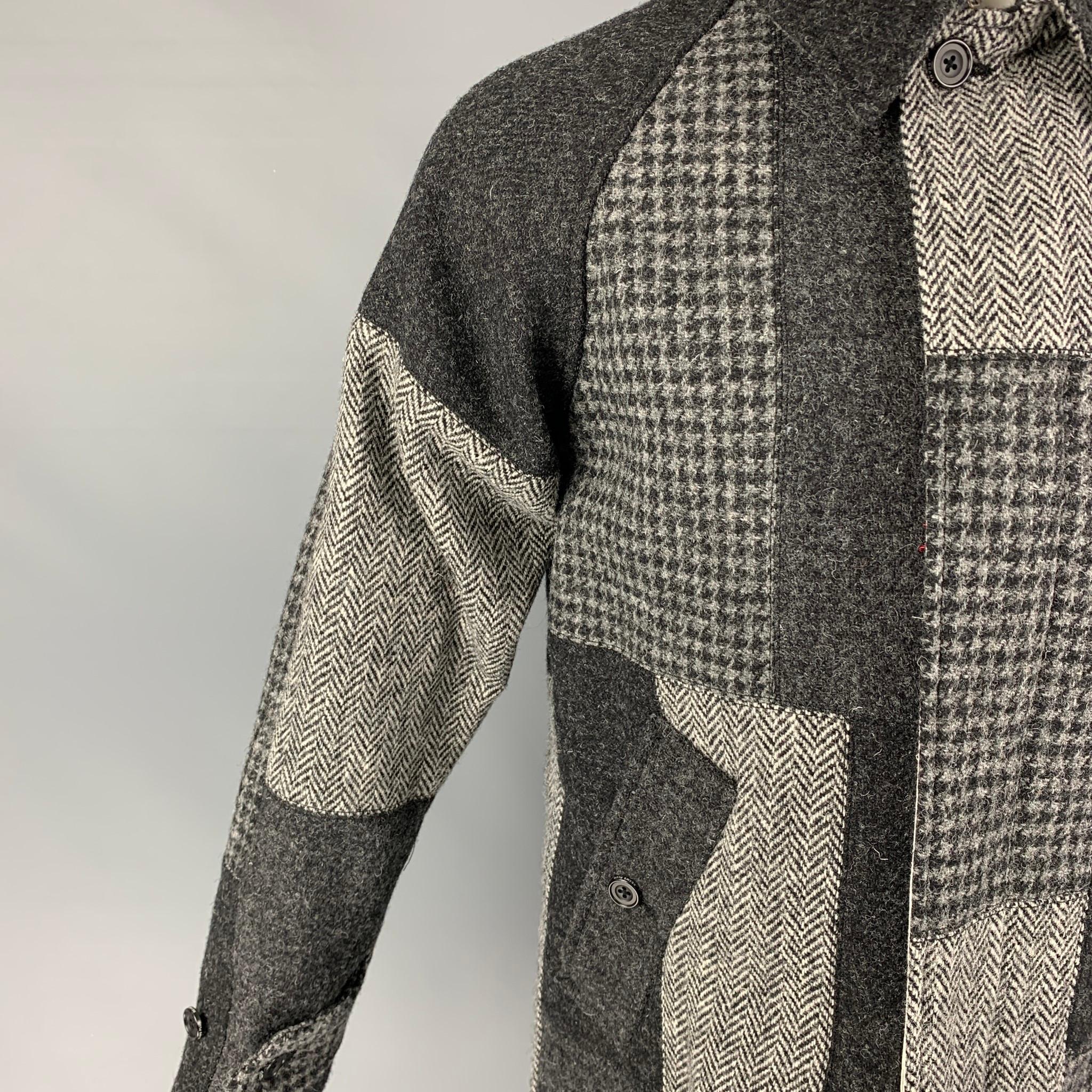 BEAMS PLUS x HARRIS TWEED coat comes in a grey patchwork wool with a full liner featuring a pointed collar, slit pockets, single back vent, and a hidden placket closure. Made in Japan. 

New with tags. 
Marked: S

Measurements:

Shoulder: 25