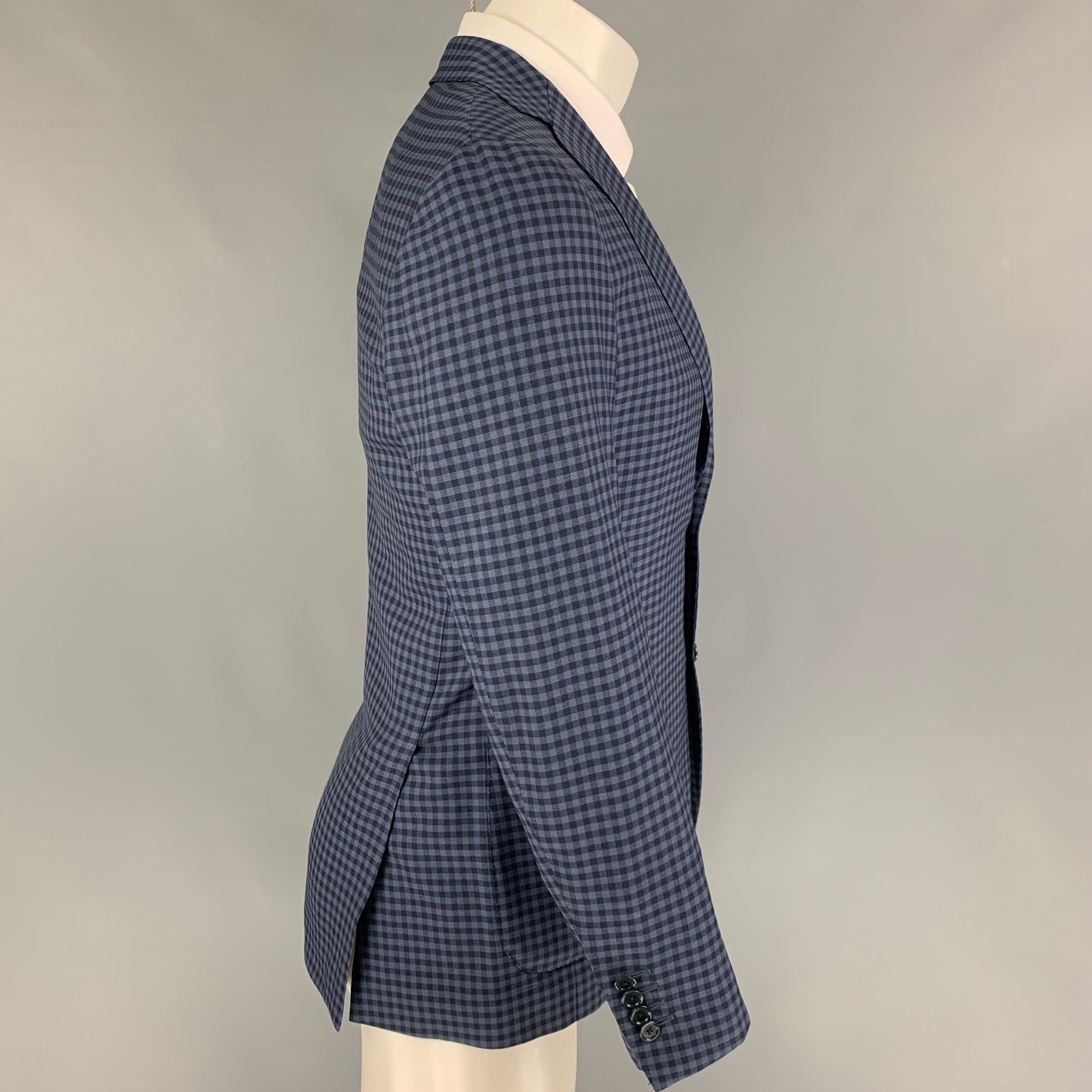 BEAMS sport coat comes in a nav & blue checkered wool with a half liner featuring a notch lapel, patch pockets, double back vent, and a three button closure. Made in Japan. 

Very Good Pre-Owned Condition.
Marked: 93

Measurements:

Shoulder: 16.5