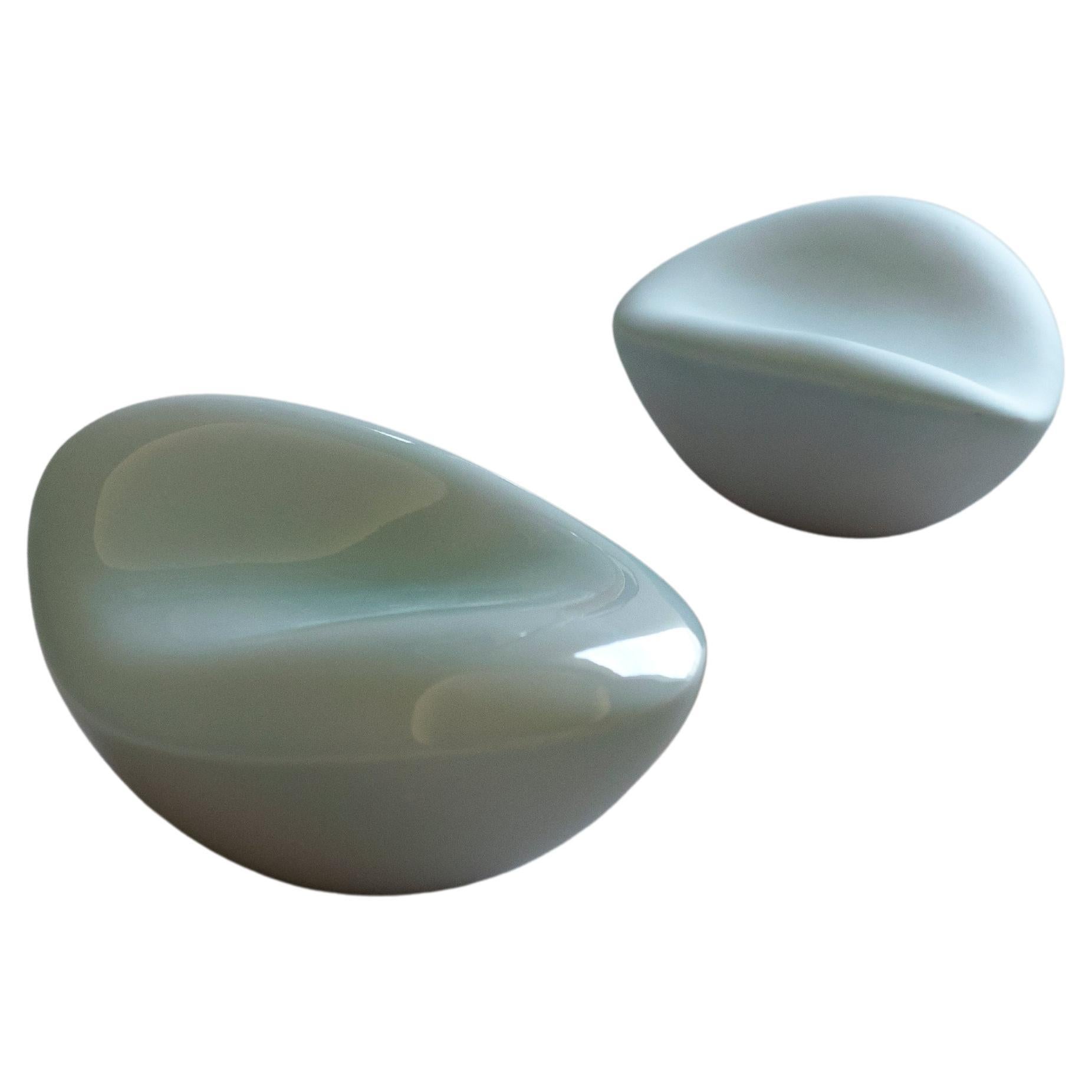 'Bean' by Soo Joo is a unique pair of abstract table sculptures, created in porcelain ceramic and Korean celadon glaze. These biophilic ceramic sculptures  have a timeless beauty that is not affected by changing trends. The sculptures fit into any