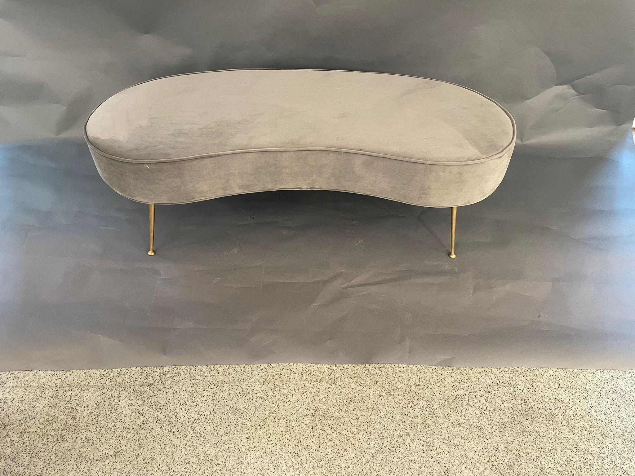 An Italian designed bean shaped bench upholstered in grey velvet and brass legs. Circa 1980s. 