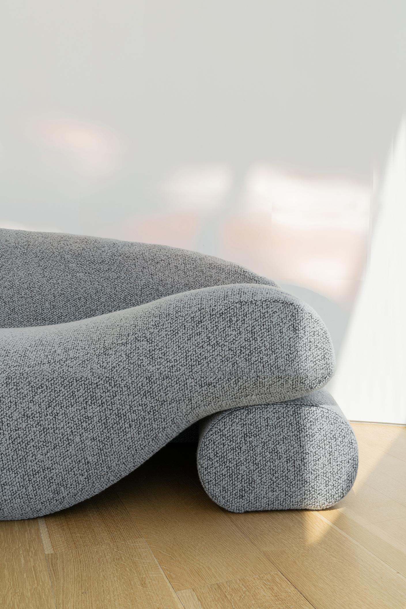 The Beanie Sofa is a comfortable textile covered sofa whose seat is comprised of one long bean bag. The sofa incorporates daybeds facing opposite directions. Its soft structure is filled with organic latex and lentil beans, which support the natural