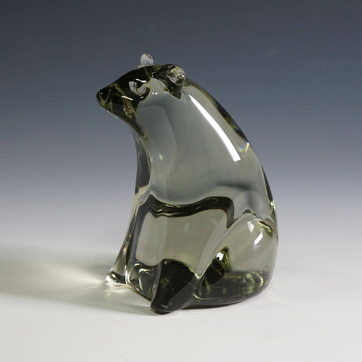 Bear Artglass sculpture Designed by Livio Seguso, circa 1970s

A stylized sculpture of a bear in solid smoke grey glass. It is hand made in the Gral glass manufactory, Germany. Designed by glass artist Livio Seguso in the 1970s. The base with