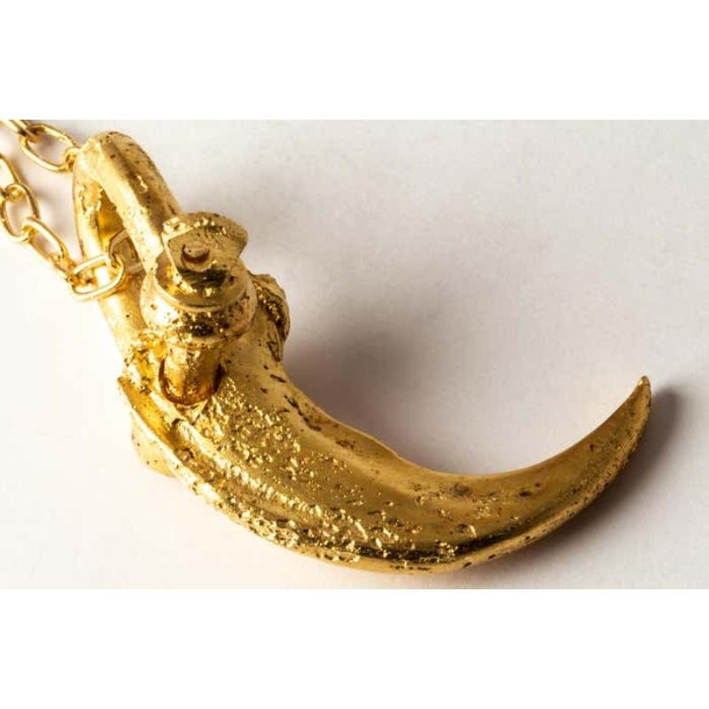 Pendant necklace in the shape of a bear claw in gold plated brass, it comes on a 74cm sterling silver chain. Brass and sterling silver substrates are electroplated with 18k gold and then dipped into acid to create the subtly destroyed surface. This