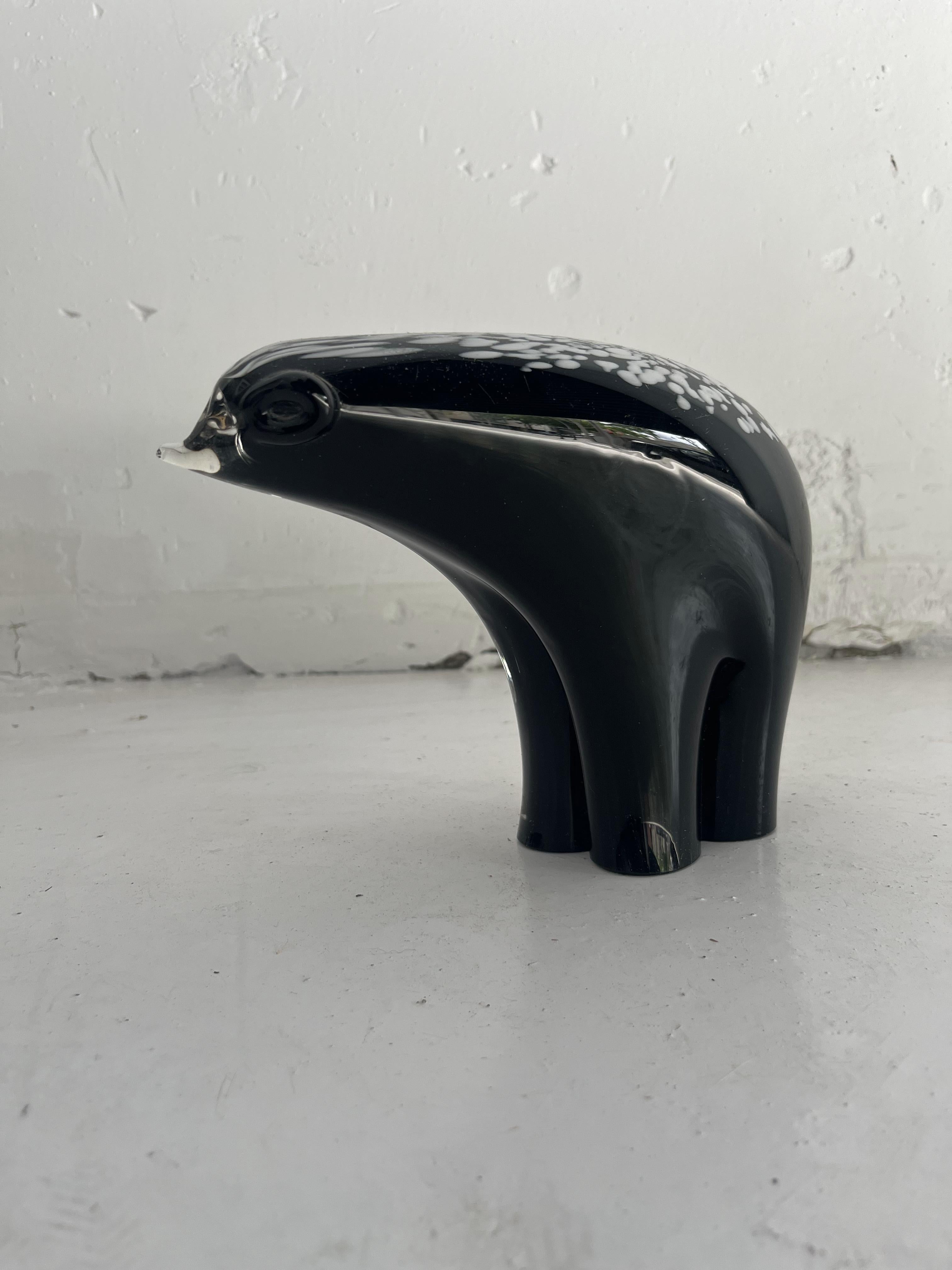 Be captivated by the grace and sophistication of our Murano Glass Polar Bear, a masterful work from the renowned V. Nason & C workshop. This sculpture, created with the meticulous Sommerso glass technique, elegantly fuses black and white tones in a