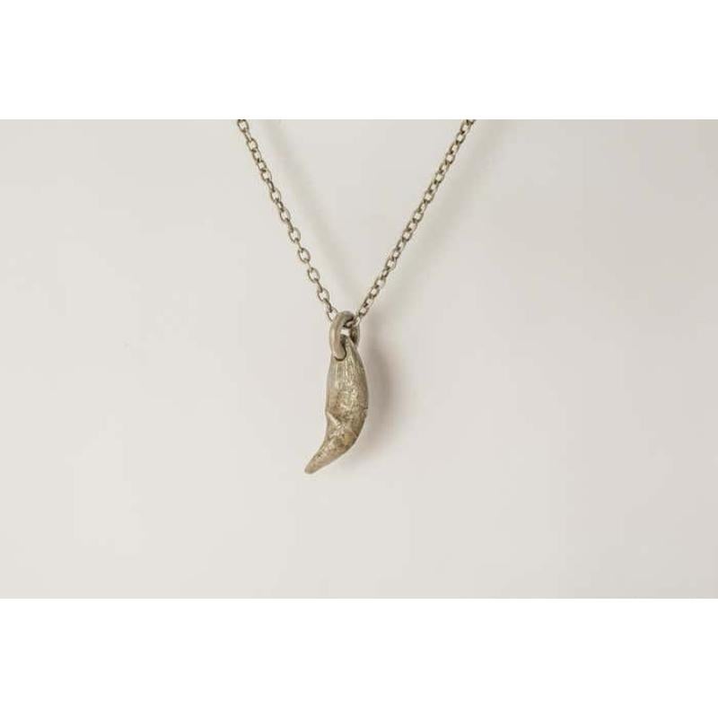 Pendant necklace in the shape of a bear tooth in brass, it comes on a 74cm sterling silver chain. Brass substrate is electroplated with silver and then dipped into acid to create the subtly destroyed surface. This item is made with deep respect to