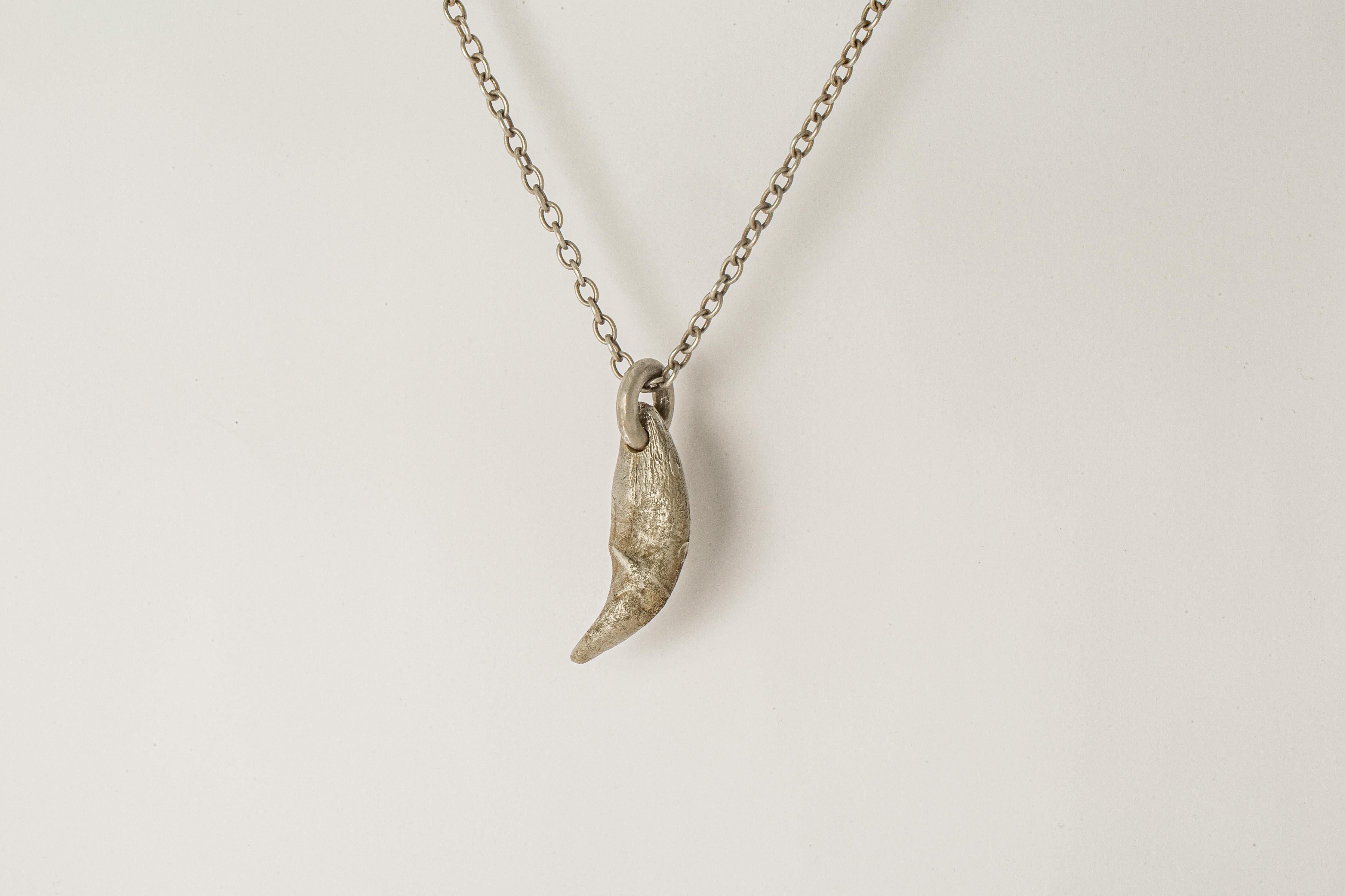 Pendant necklace in the shape of a bear tooth in brass, it comes on a 74cm sterling silver chain. Brass substrate is electroplated with silver and then dipped into acid to create the subtly destroyed surface. This item is made with deep respect to
