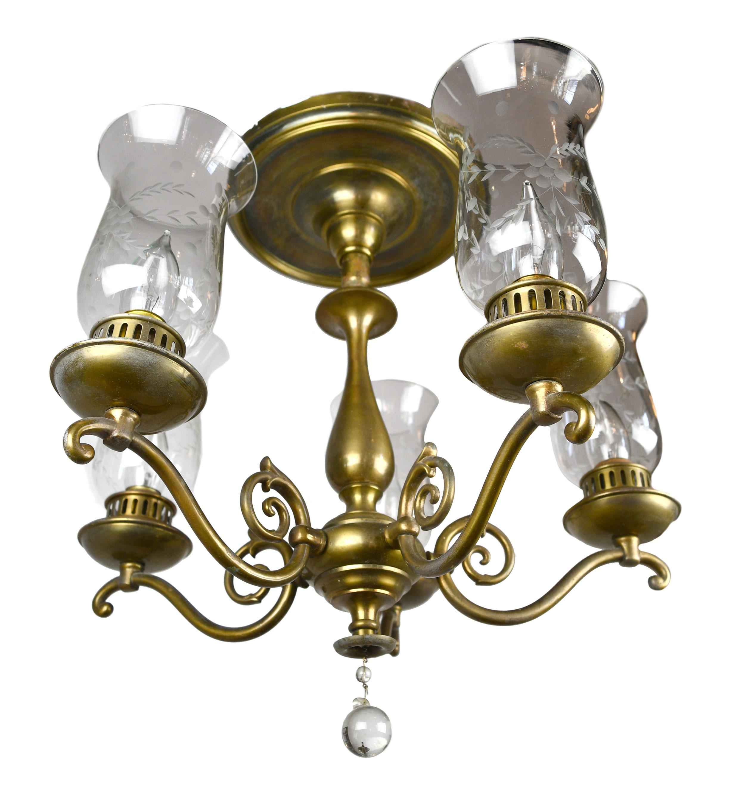 This lovely Beardslee chandelier features a Classic Federal style, handsome brass and 5 floral hurricane shades.
