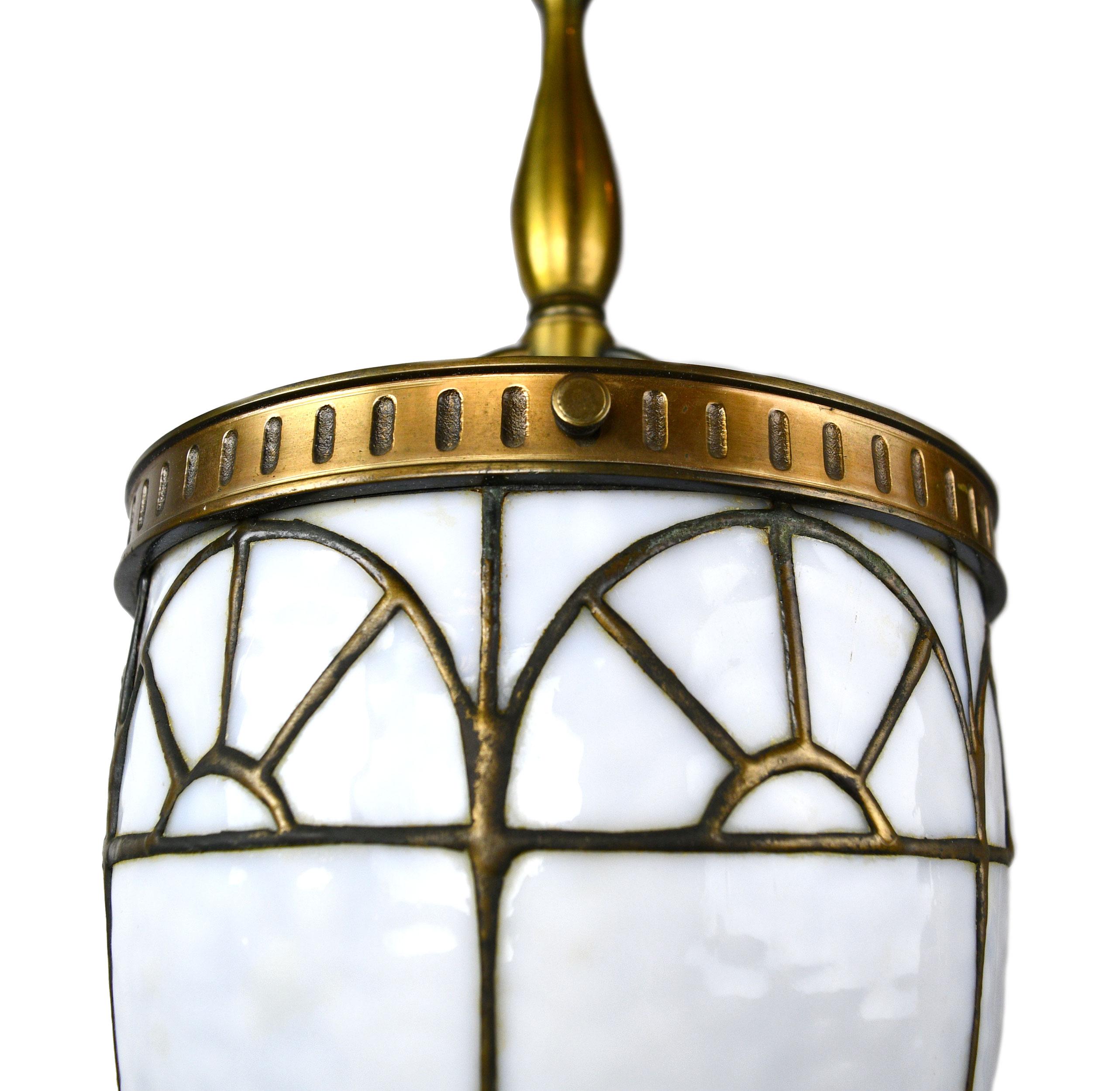 These Beardslee pendants are of brass, bronze & mottled bent glass and features a geometrically symmetrical design throughout the shade and fixture. Original patina on theses lights needs to be seen to believe! 

This fixture is only part of the