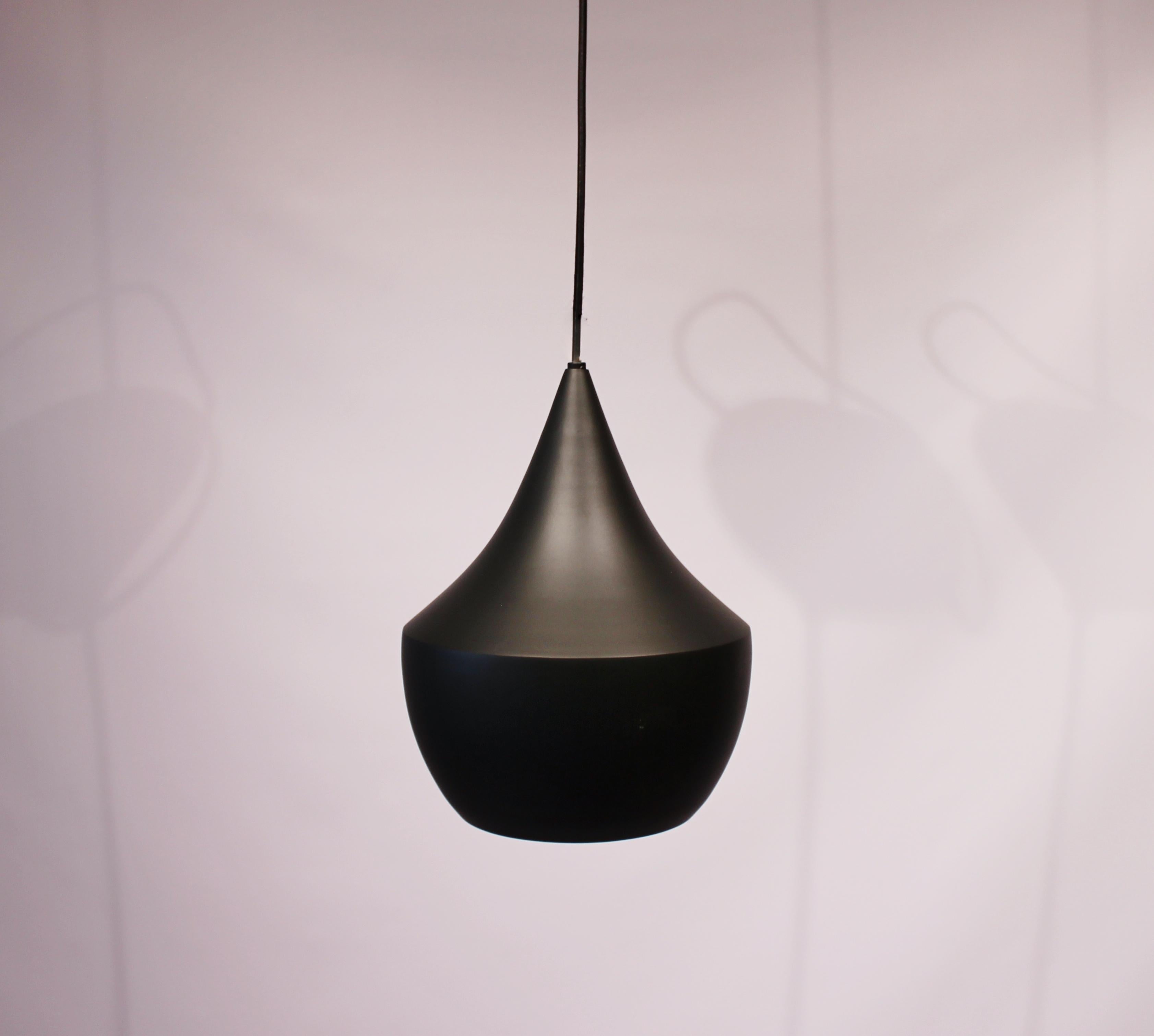 Beat pendant, model BLA01EU, in the color black and in brass designed by Tom Dixon. The lamp is in great vintage condition.