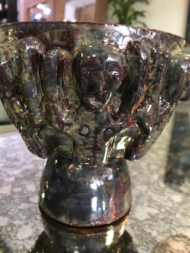 A wonderful and whimsical piece by famed American/ California ceramist Beatrice wood featuring a mixture of mottled glazes and arm-raised figures.

Signed with her traditional 