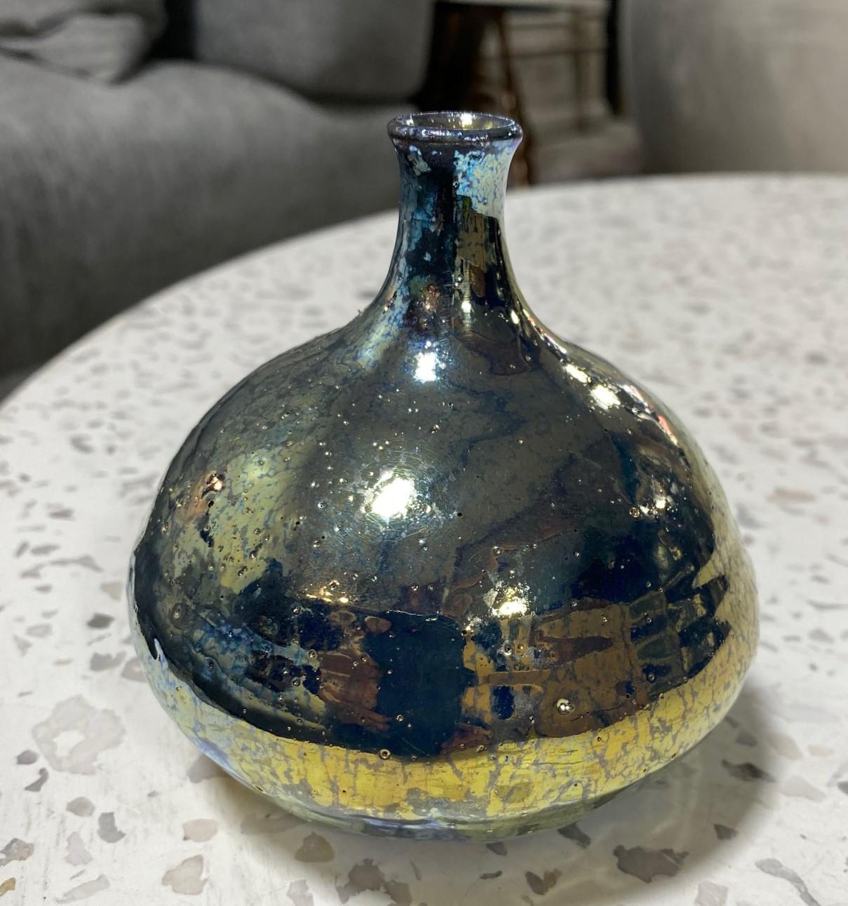 A wonderful gem of a piece by famed American/California ceramicist Beatrice Wood featuring her highly coveted, and somewhat rare iridescent gold luster glaze. The gorgeous and sumptuous glaze radiants various shades and colors (golds, blues, greens,