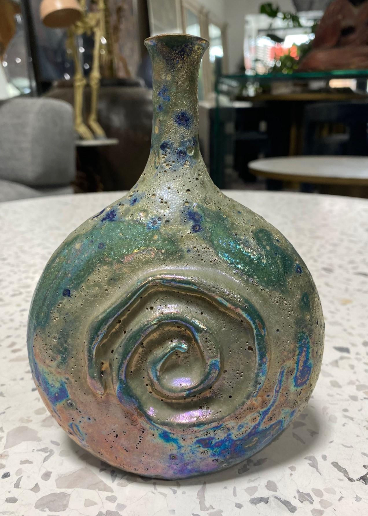 A wonderfully designed work by famed American California Studio master ceramist Beatrice Wood featuring a gorgeous, sumptuous, iridescent luster (lustre) volcanic lava crater glaze (her most coveted glaze) with spiral decoration.  The colors shift