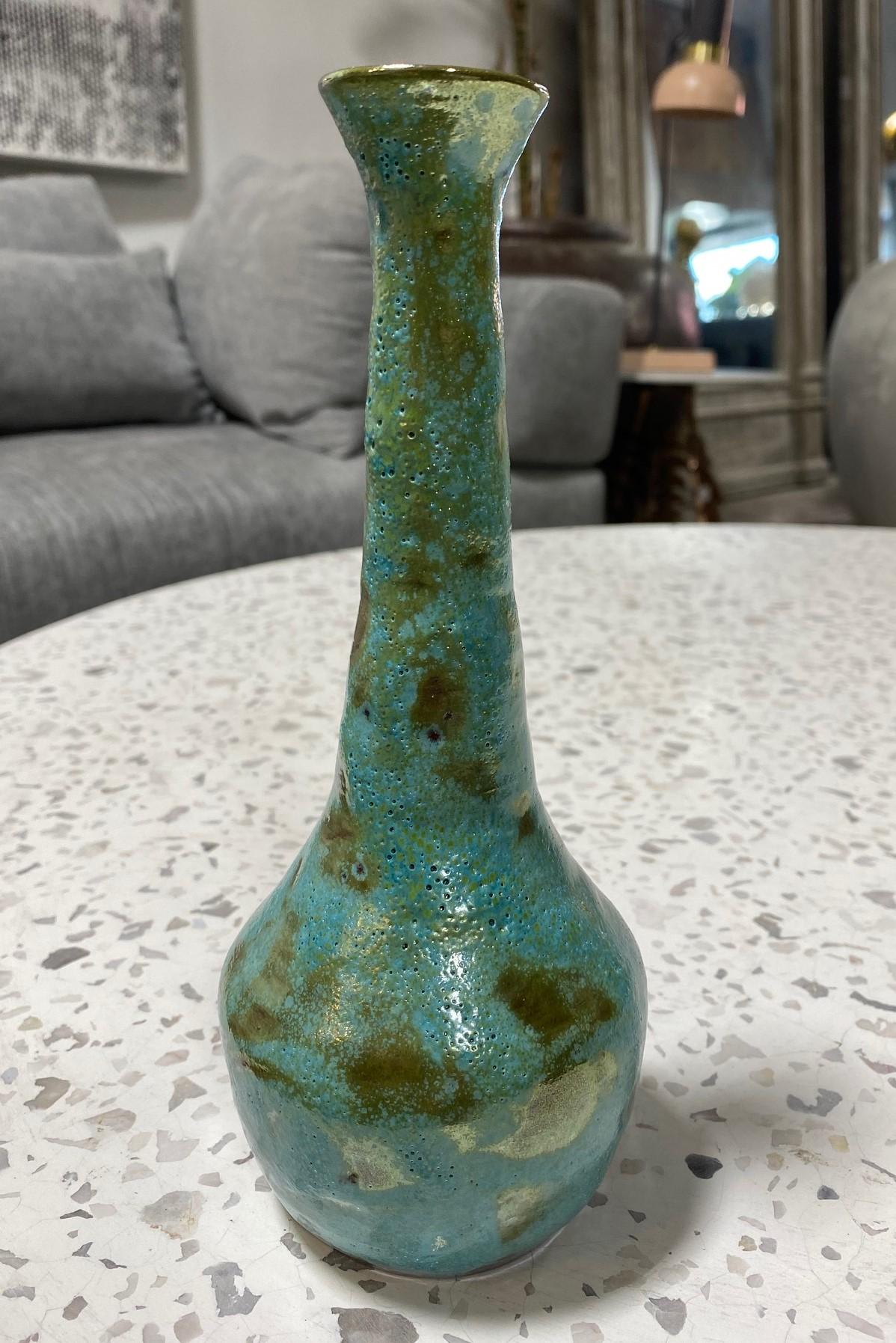 A wonderful gem of a piece by famed American/California ceramicist Beatrice Wood featuring her highly coveted, gorgeously radiant turquoise luster glaze. A beautiful design with a delicate long neck rising from a circular base. Classic and timeless.