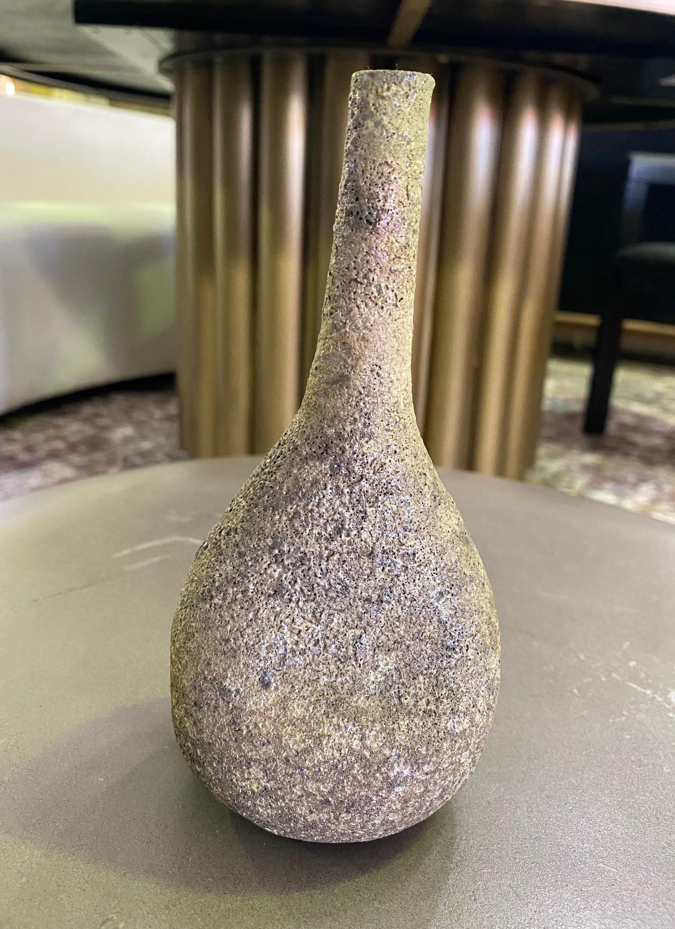 A wonderful gem of a piece by famed American ceramist Beatrice Wood featuring a gorgeous iridescent metallic muted gold and silver lava glaze - one that we have not seen before. A wonderful design with a delicate long neck rising from a circular