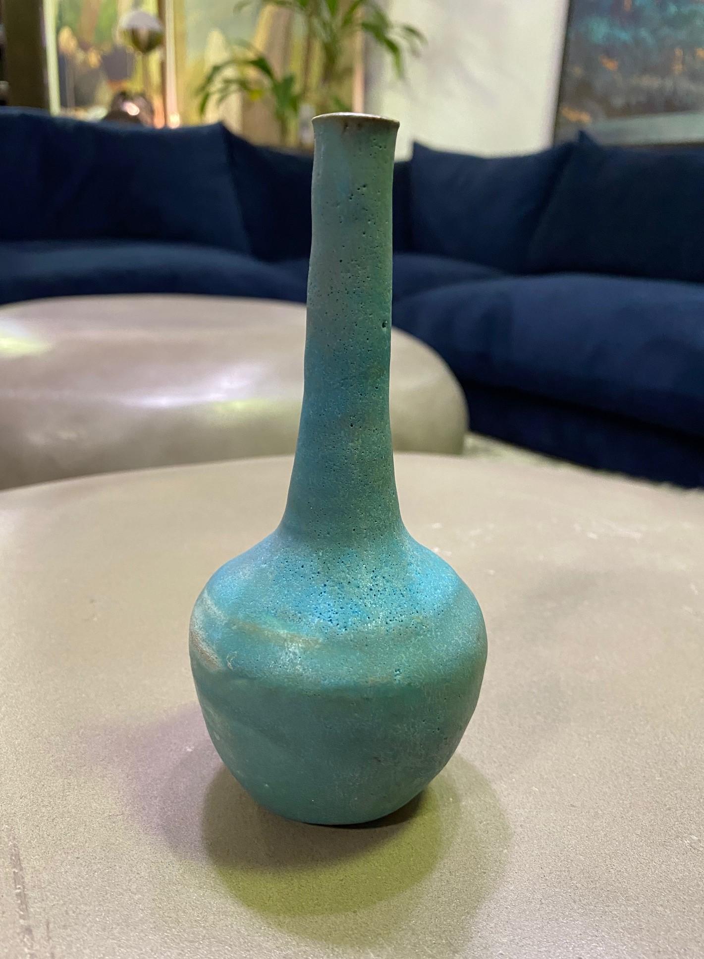 A wonderful gem of a piece by famed American ceramist Beatrice Wood featuring a gorgeous turquoise lava glaze. A wonderful design with a delicate long neck rising from a circular base. Classic and timeless. 

Signed by Beatrice in her customary