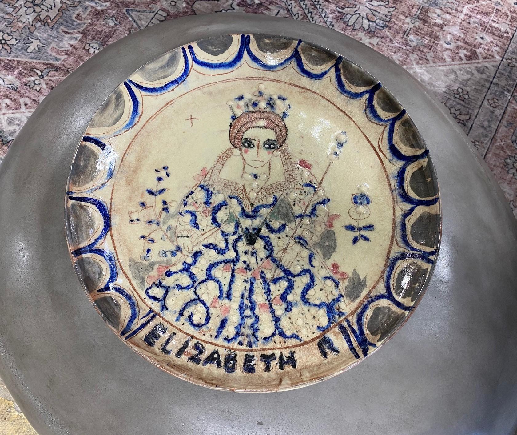 An extremely rare and wonderfully hand-painted monumentally large charger featuring a portrait of Queen Elizabeth - a quite unique and bold work by famed American/ California studio pottery ceramist Beatrice Wood. The portrait of the English Queen